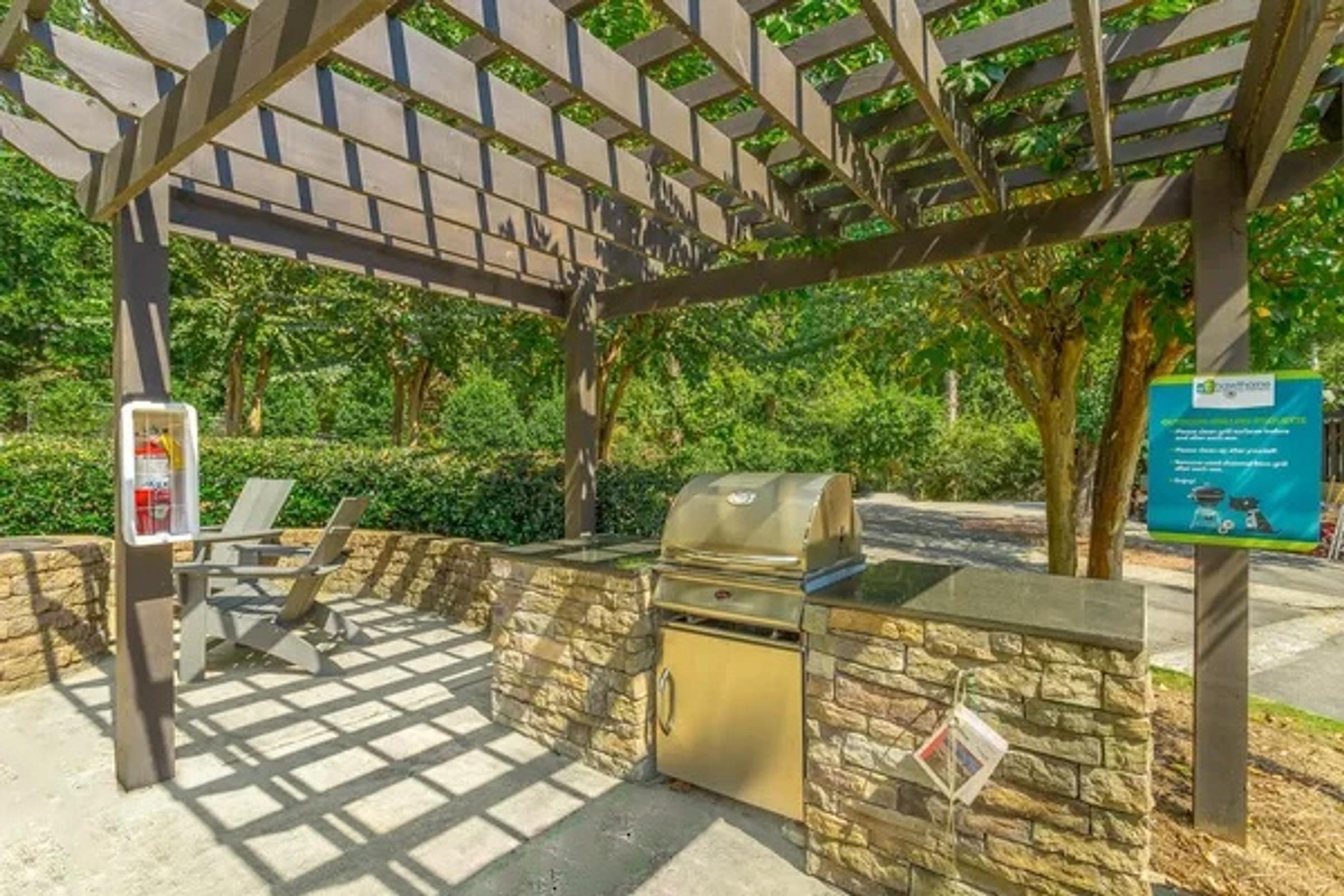 a picnic area with a grill and a picnic table