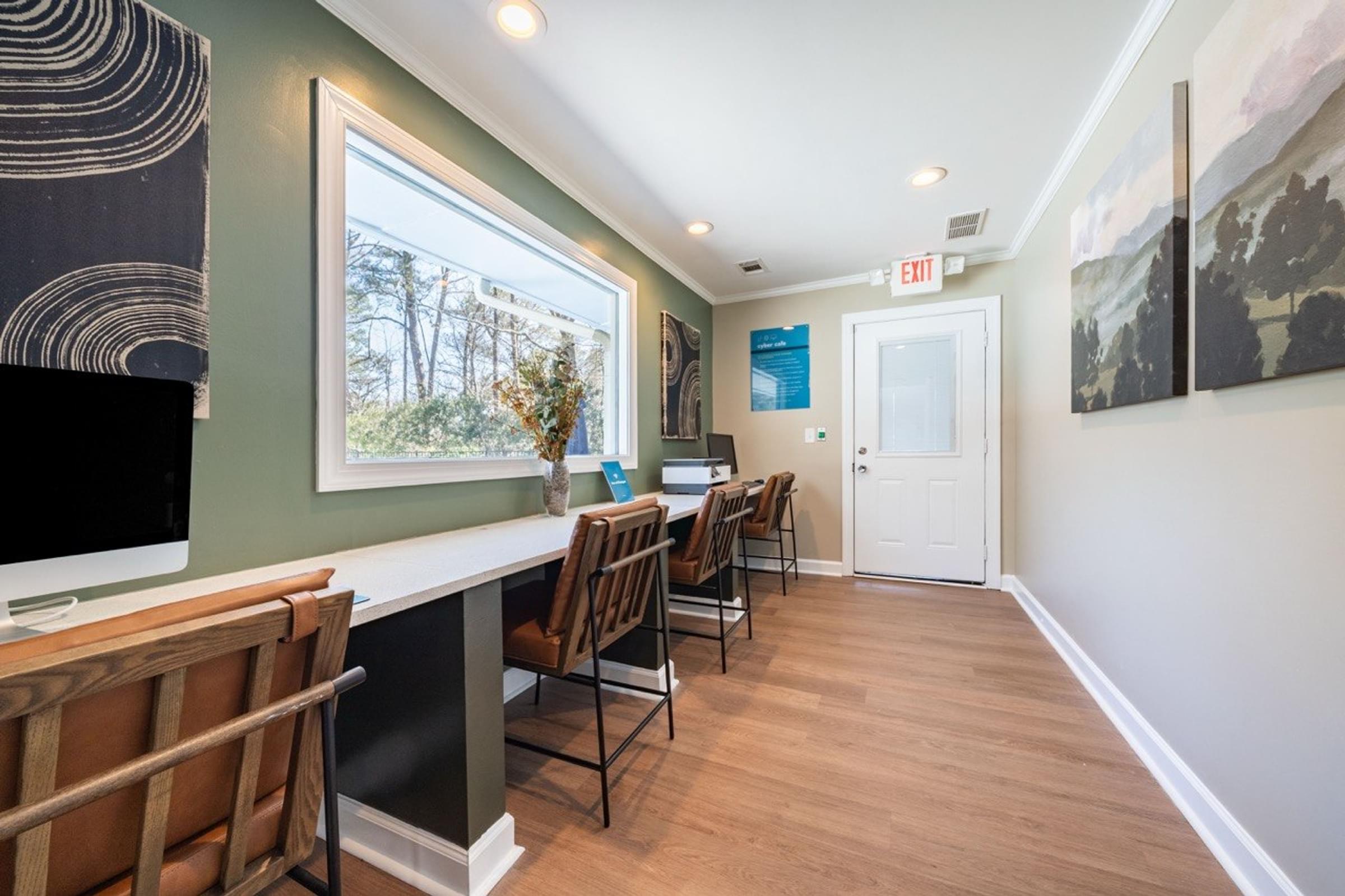 A room with a long table and chairs with a window on the left