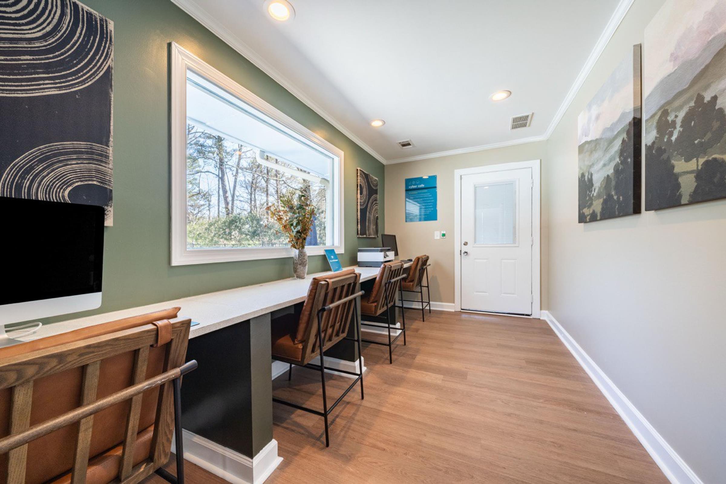 A room with a long table and chairs.
