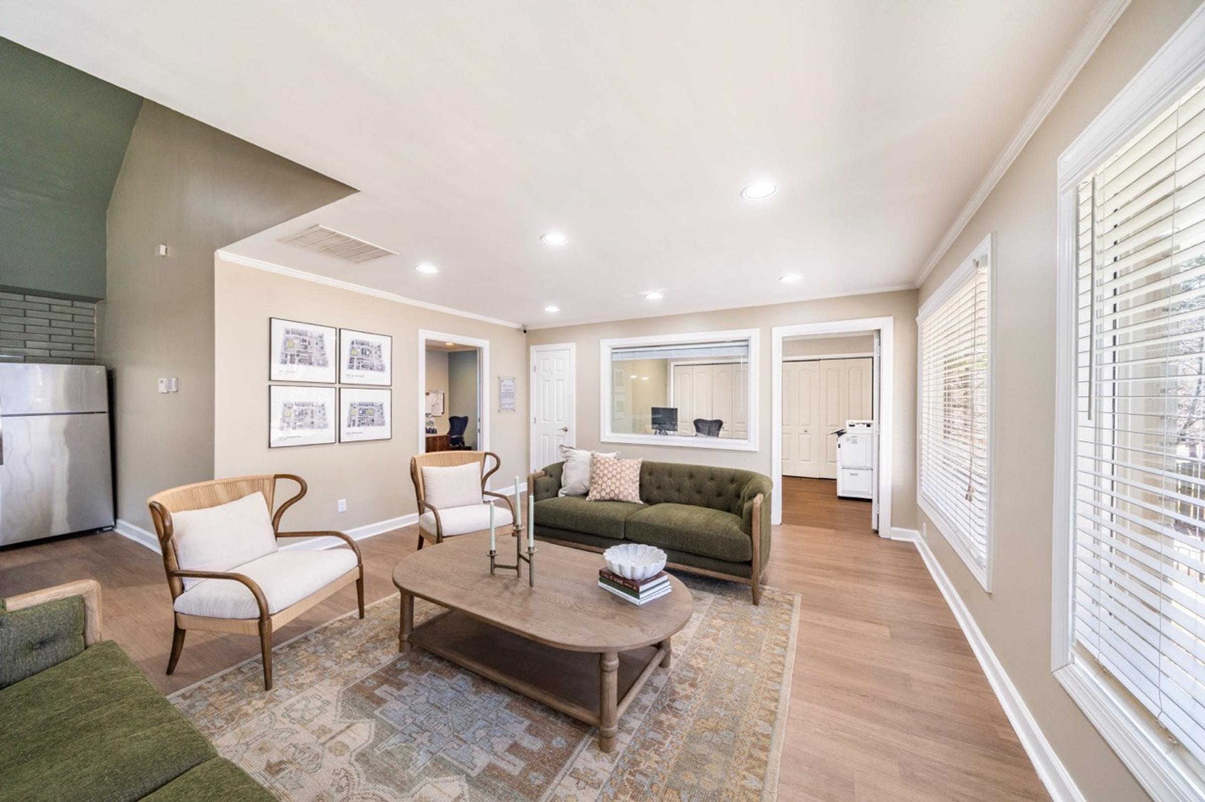 A living room with a couch, chairs, and a coffee table