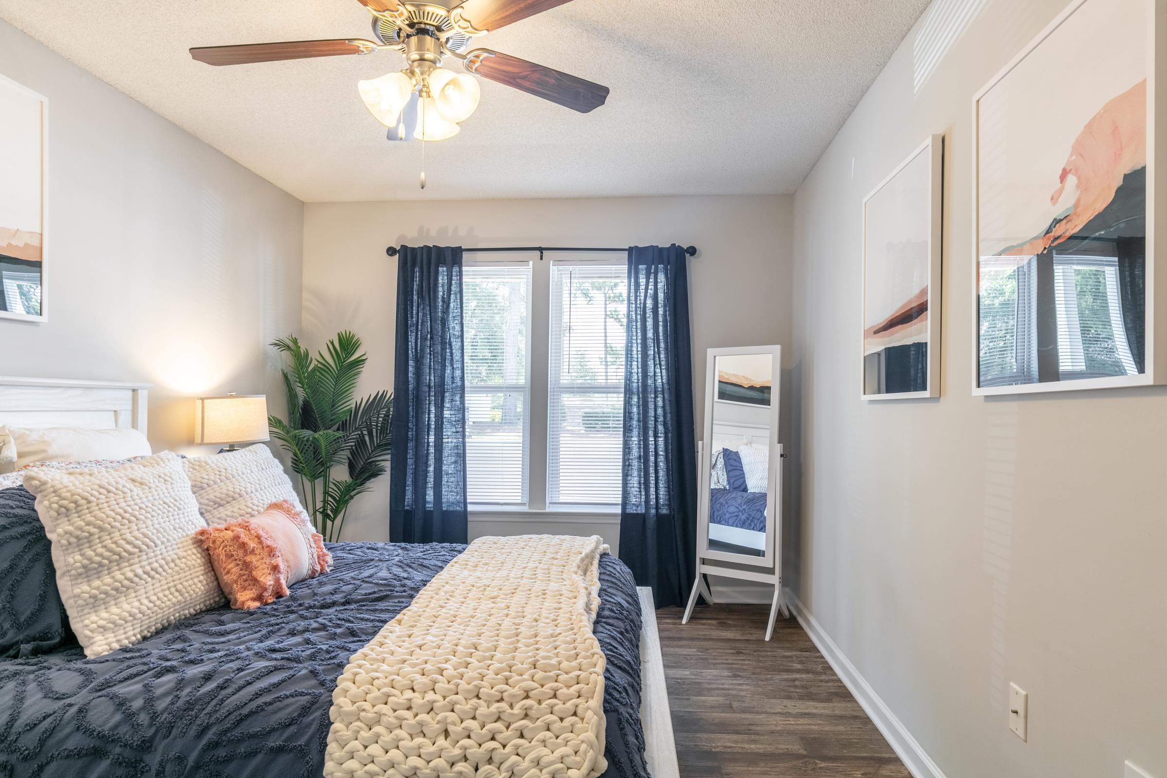 a bedroom with a bed and a ceiling fan