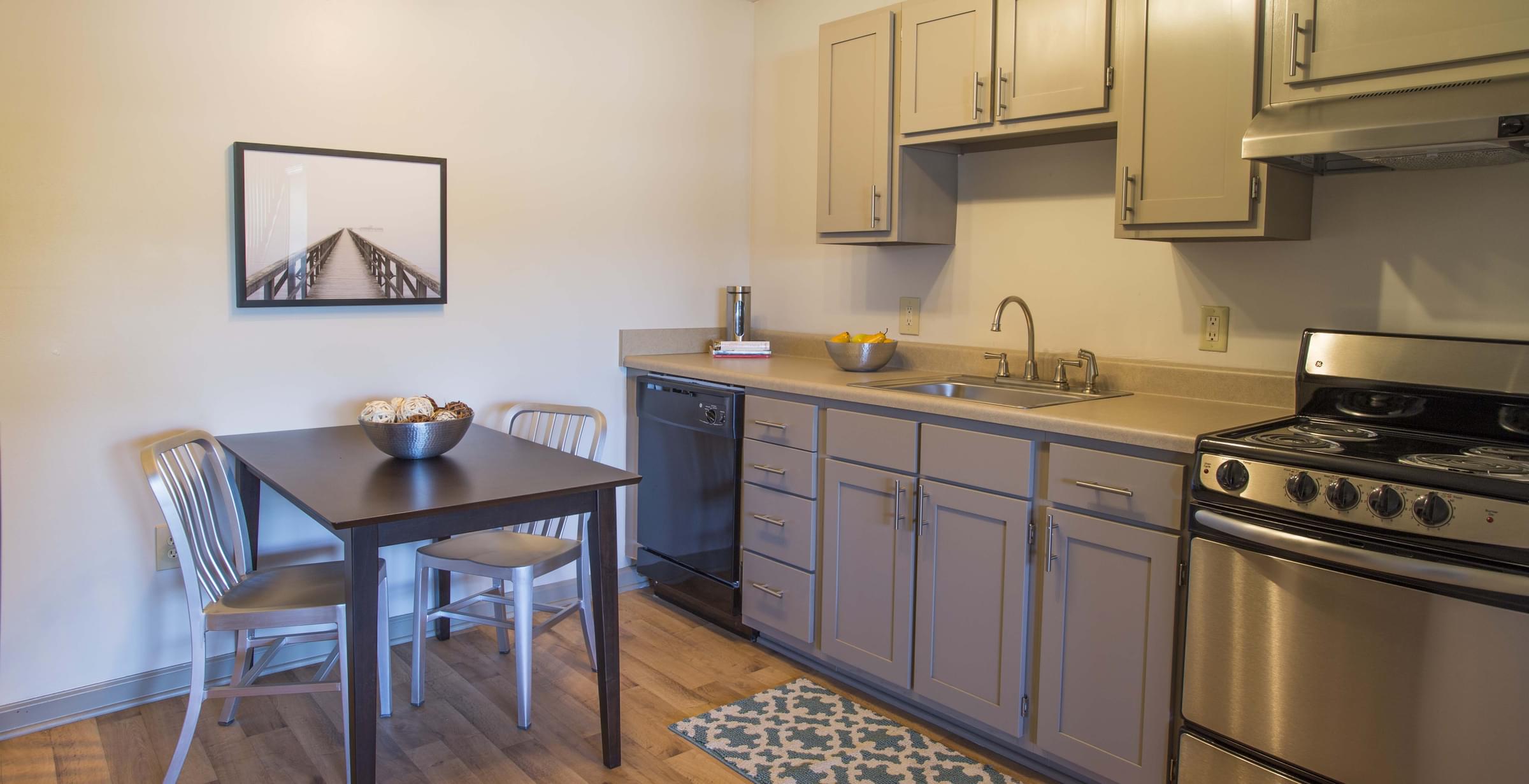 Kitchen with Sleek Black Energy Efficient Appliances and Designer Cabinetry