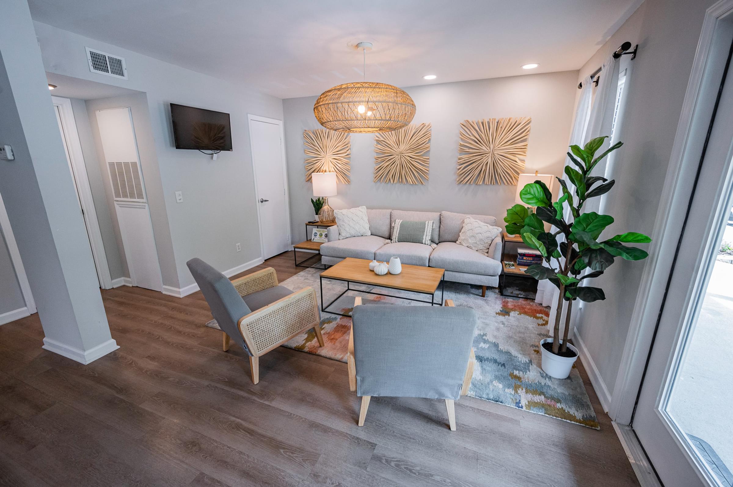 a living room with couches and chairs and a table