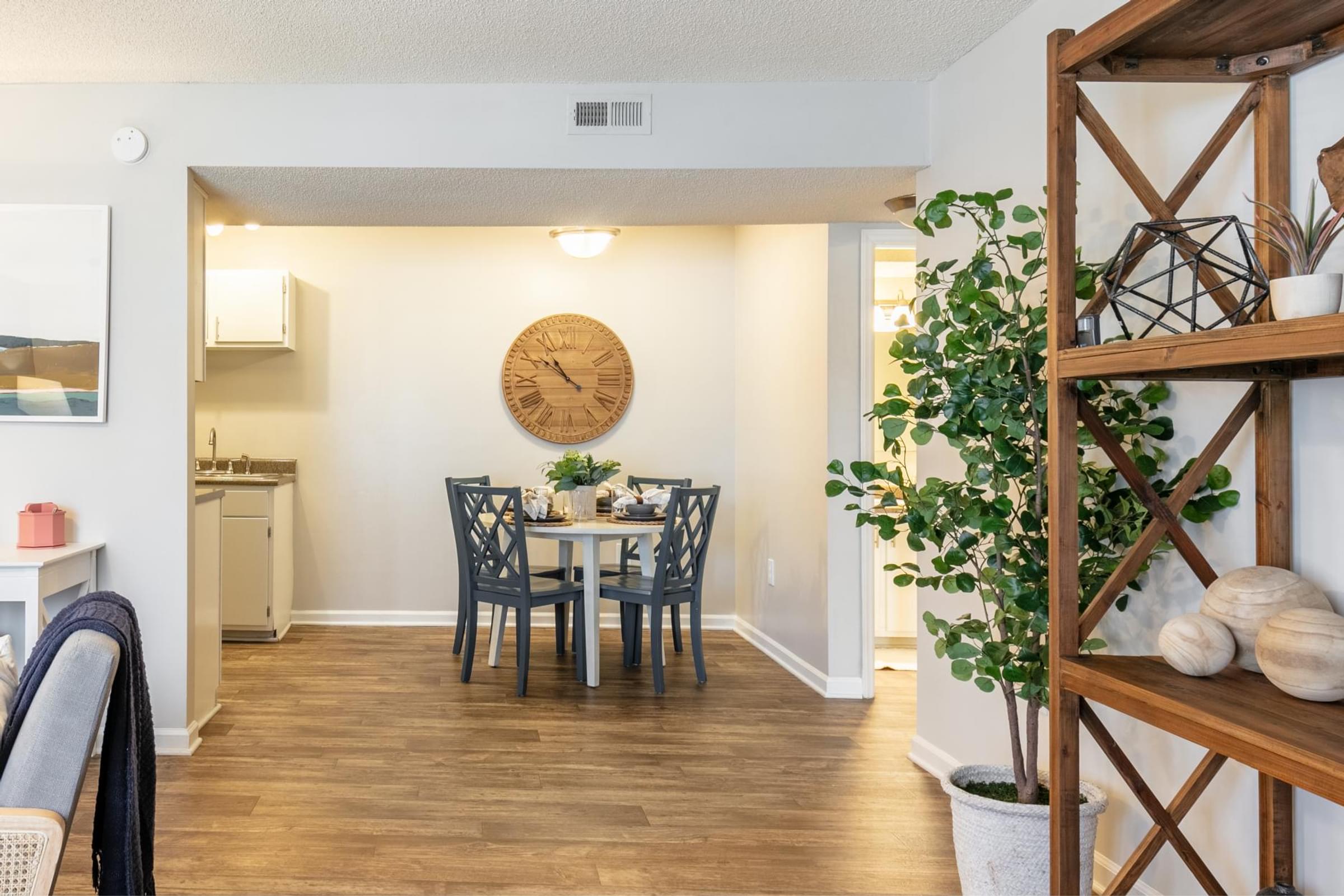 a dining room with a table and a clock on the wall