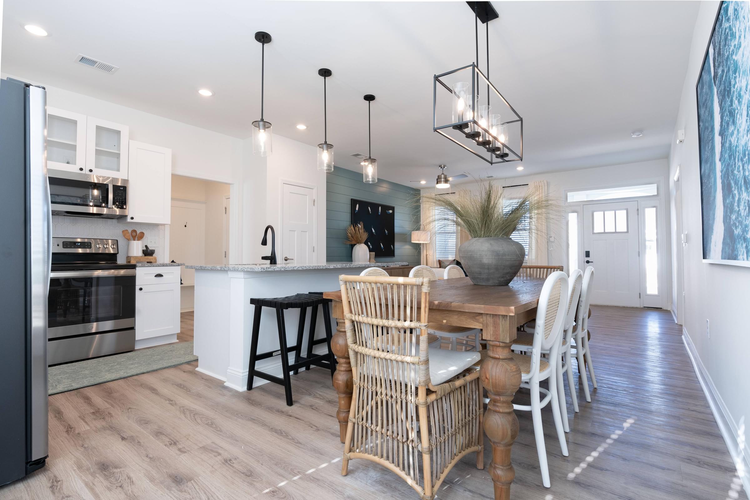 A modern kitchen with a dining table and chairs.