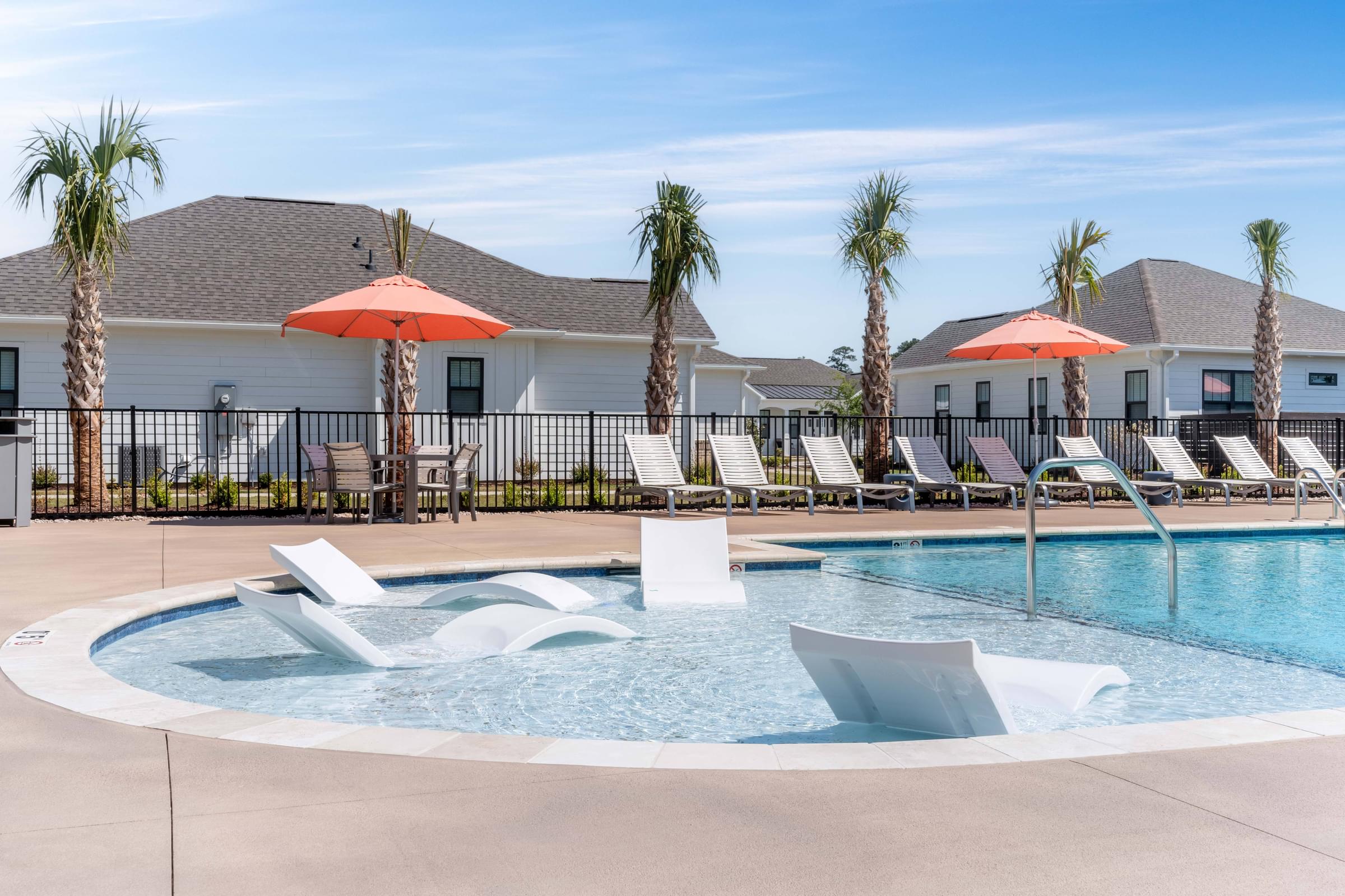 a resort style pool with lounge chairs