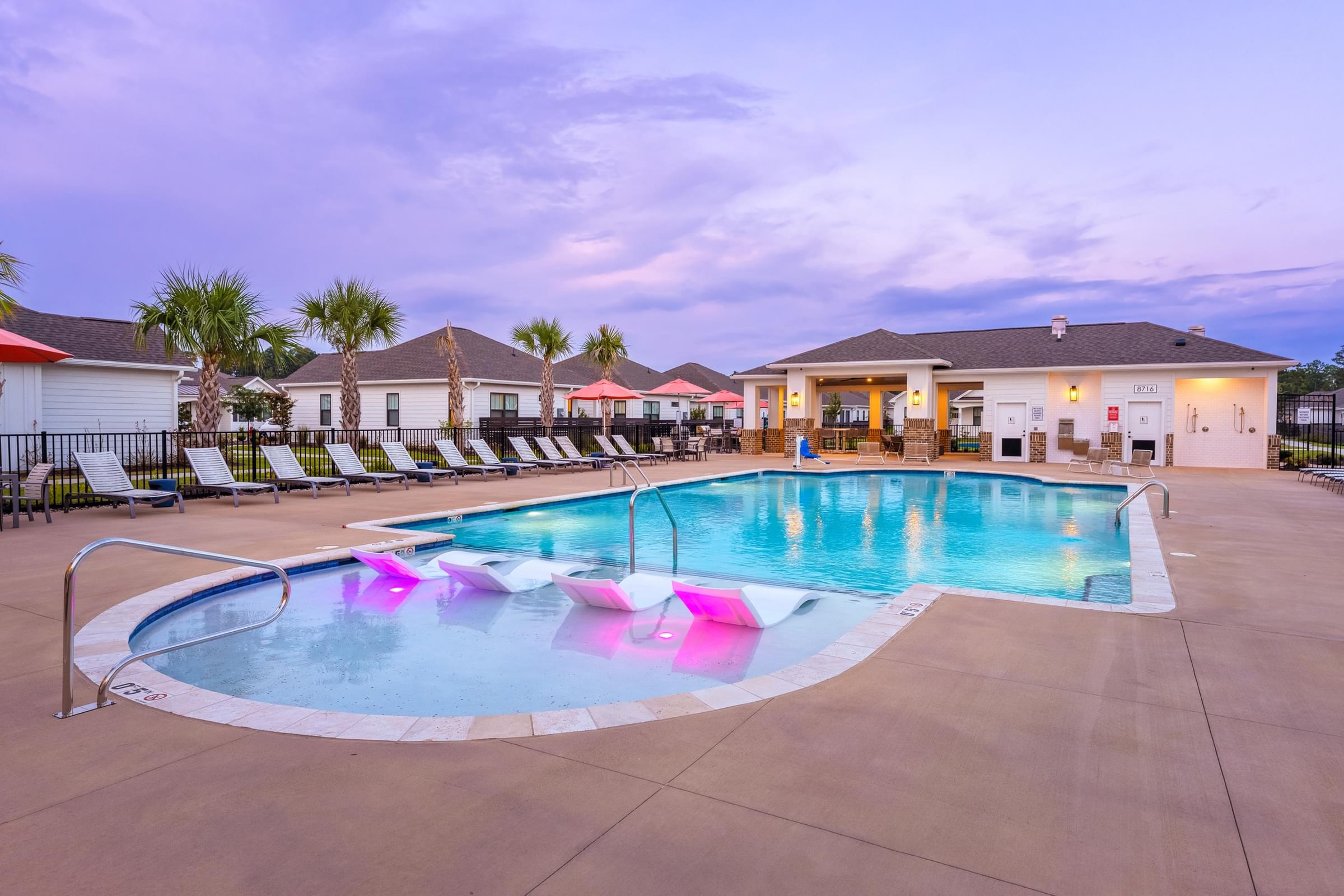 A large outdoor pool with a water slide.