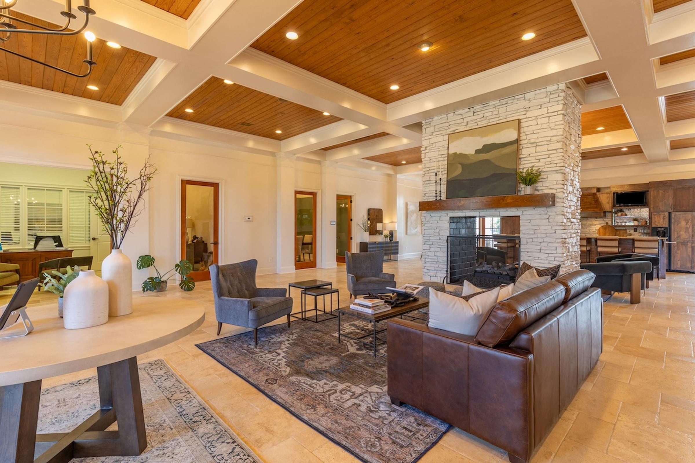 a living room with a leather couch and a fireplace
