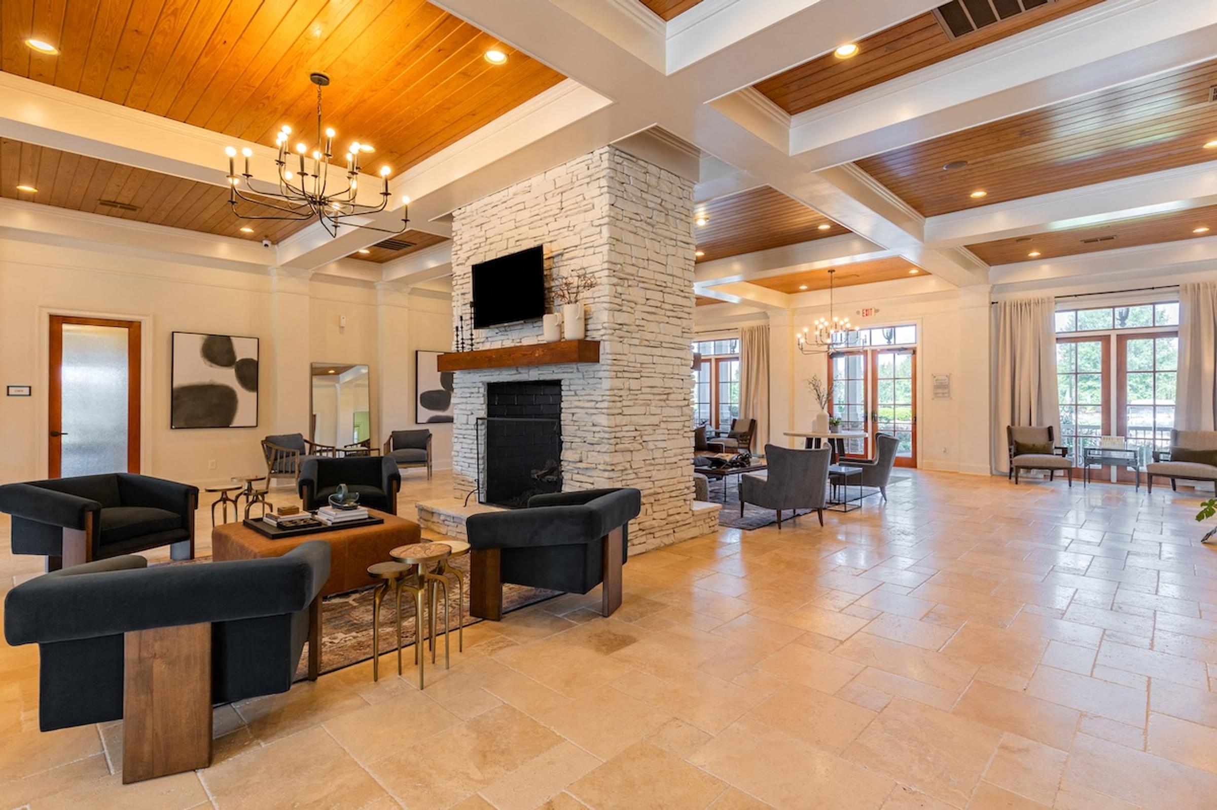 a large living room with chairs and a fireplace