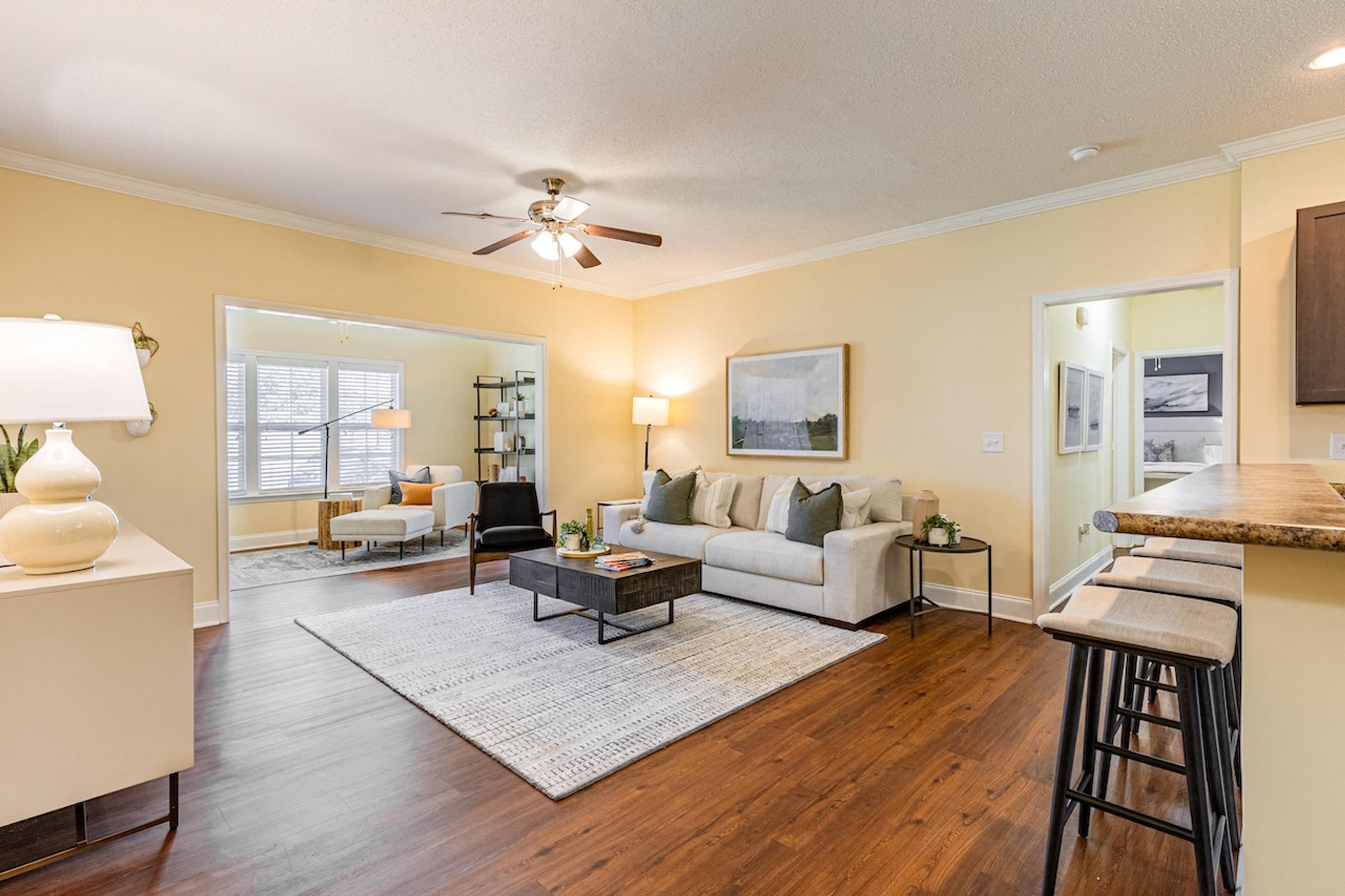 a living room with a couch and a ceiling fan