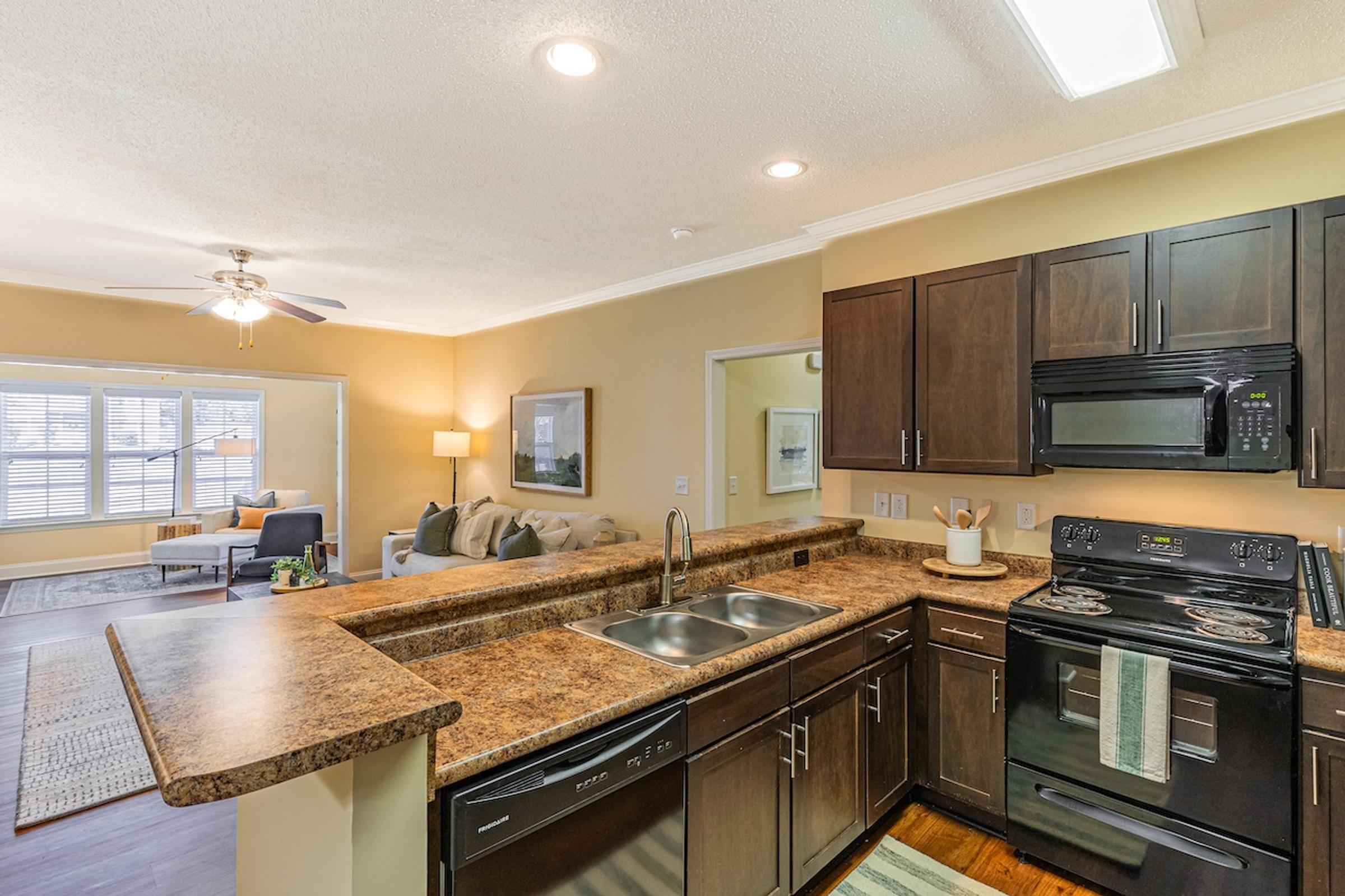 Open-Concept Kitchen Featuring Breakfast Bar and Espresso Cabinetry