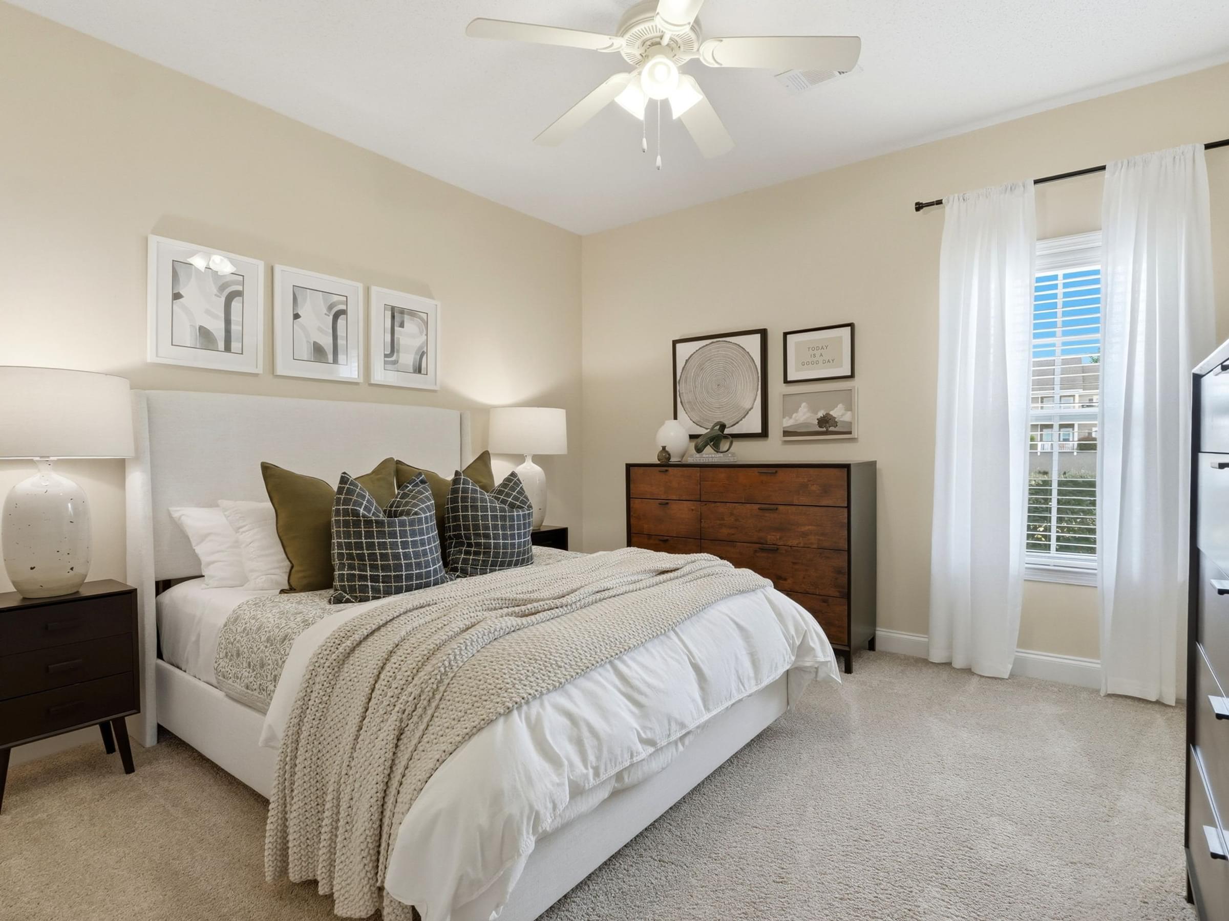 Spacious Bedroom with Large Windows and Plush Carpeting