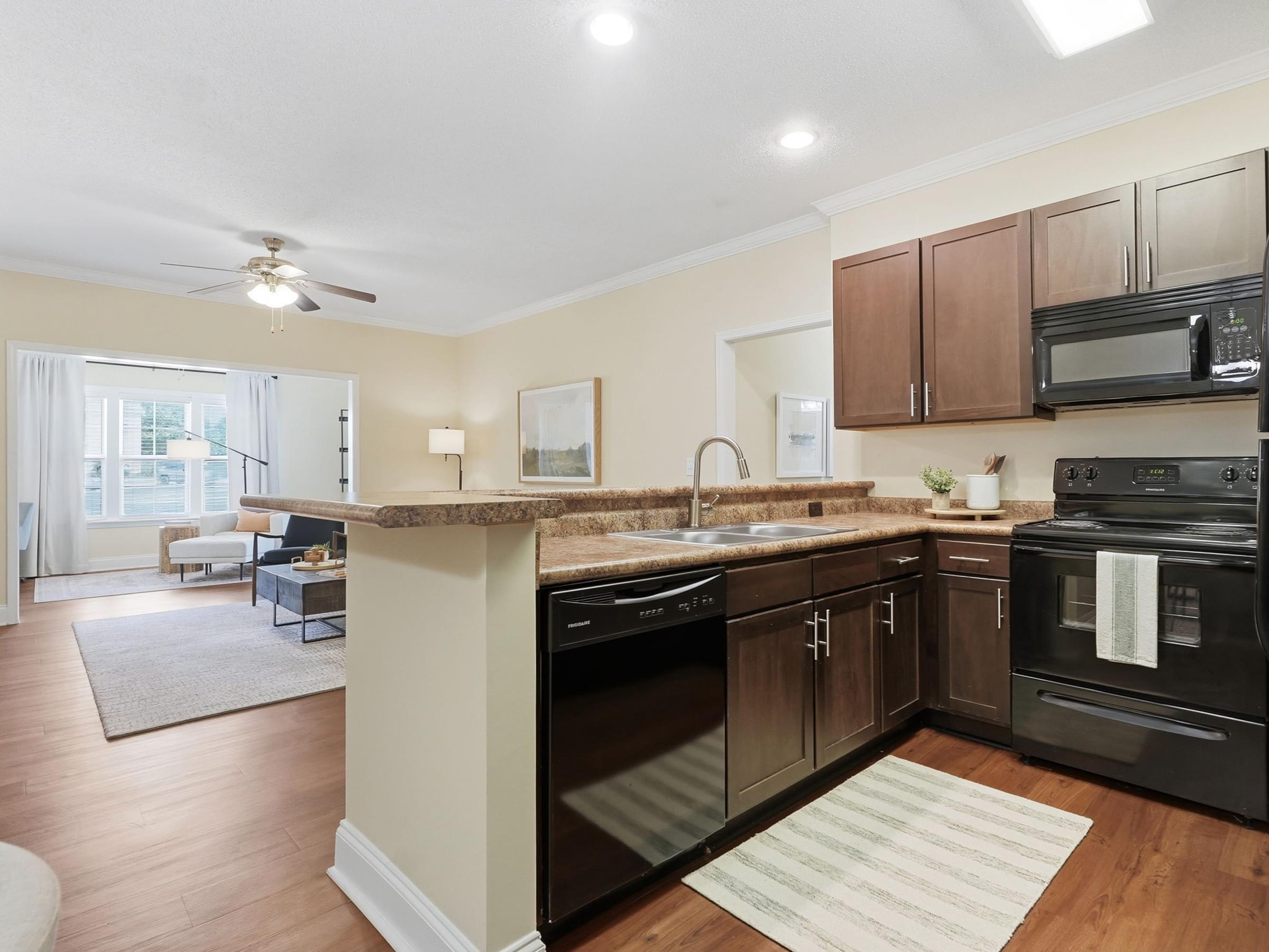 Open-Concept Kitchen Featuring Breakfast Bar and Espresso Cabinetry