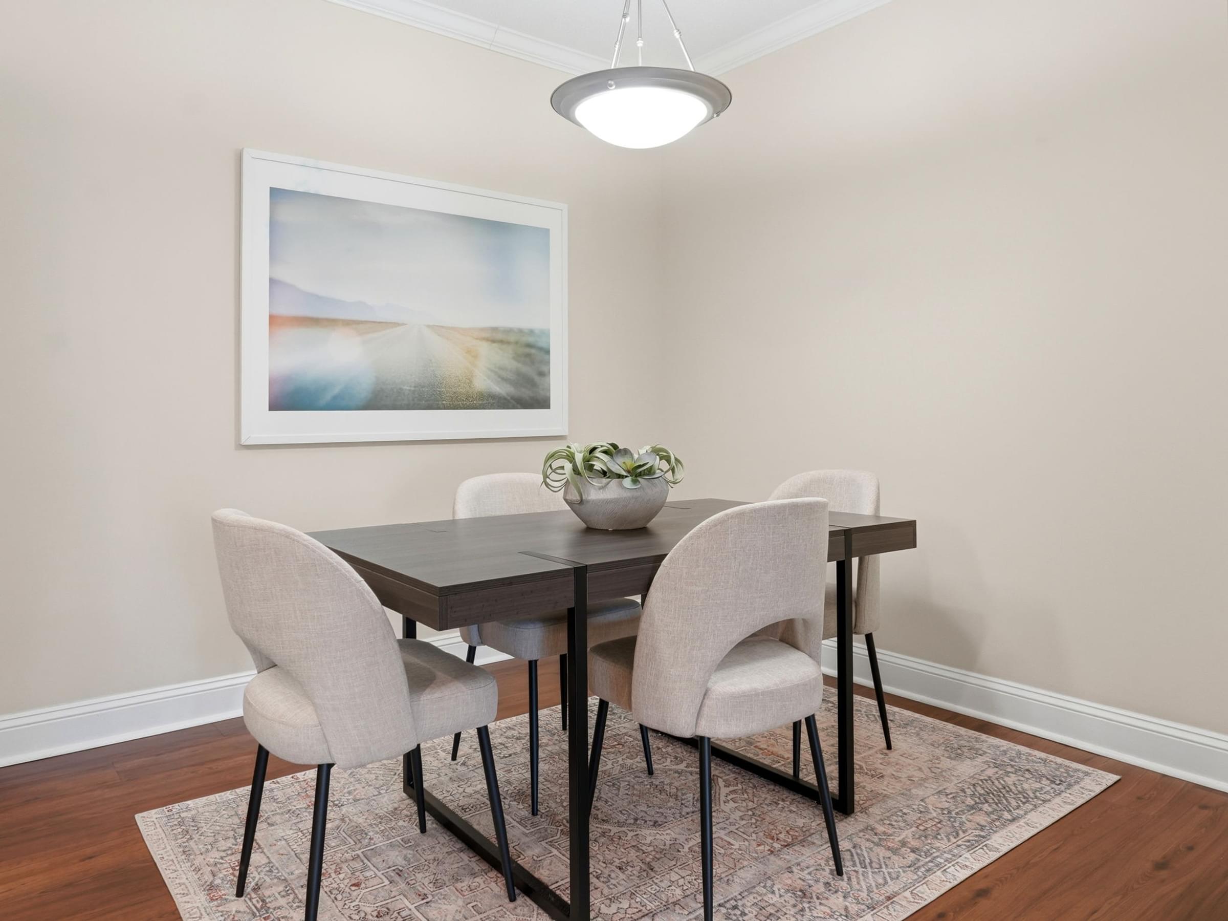 A dining room with a table and chairs.