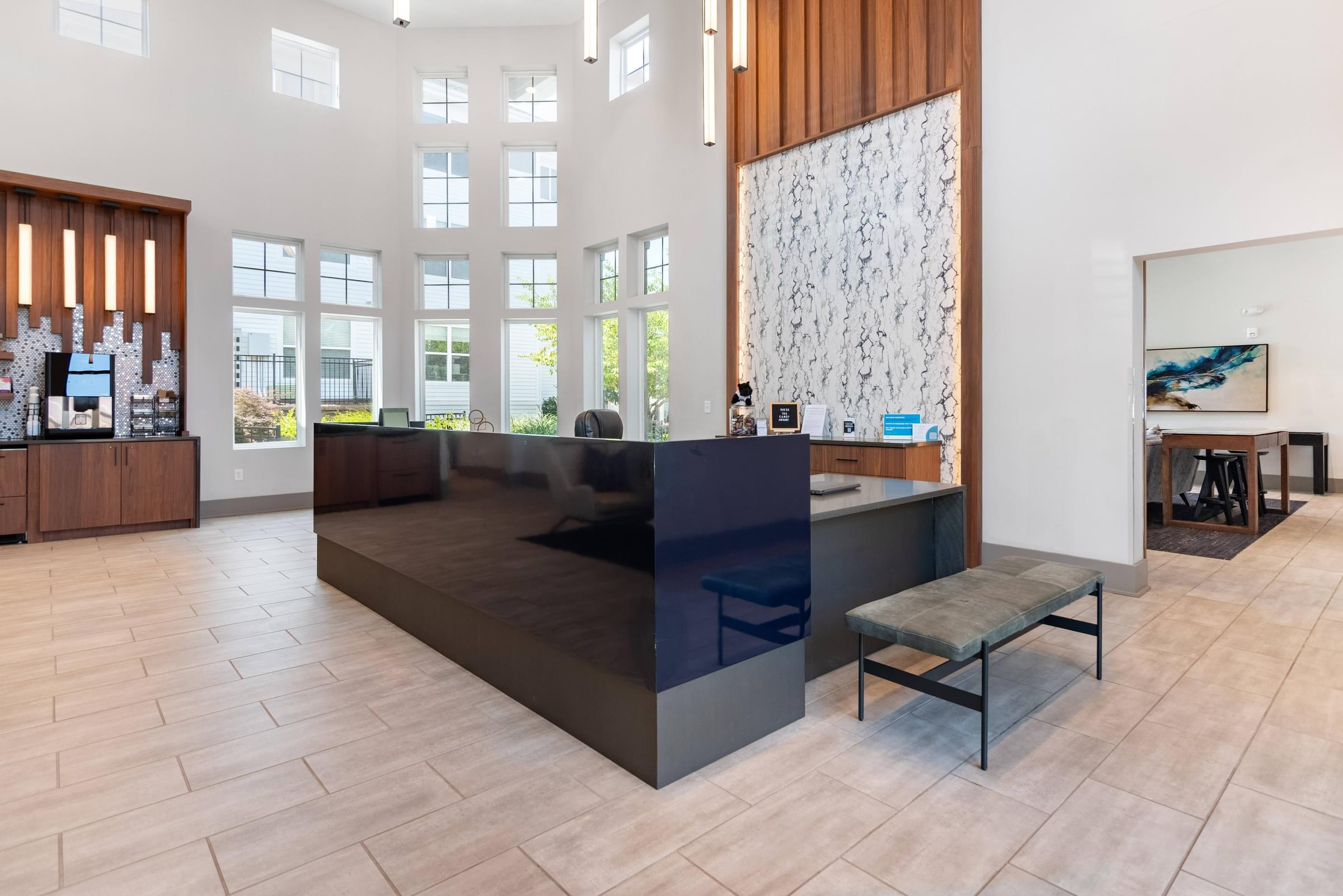 a large lobby with a reception desk and a large window
