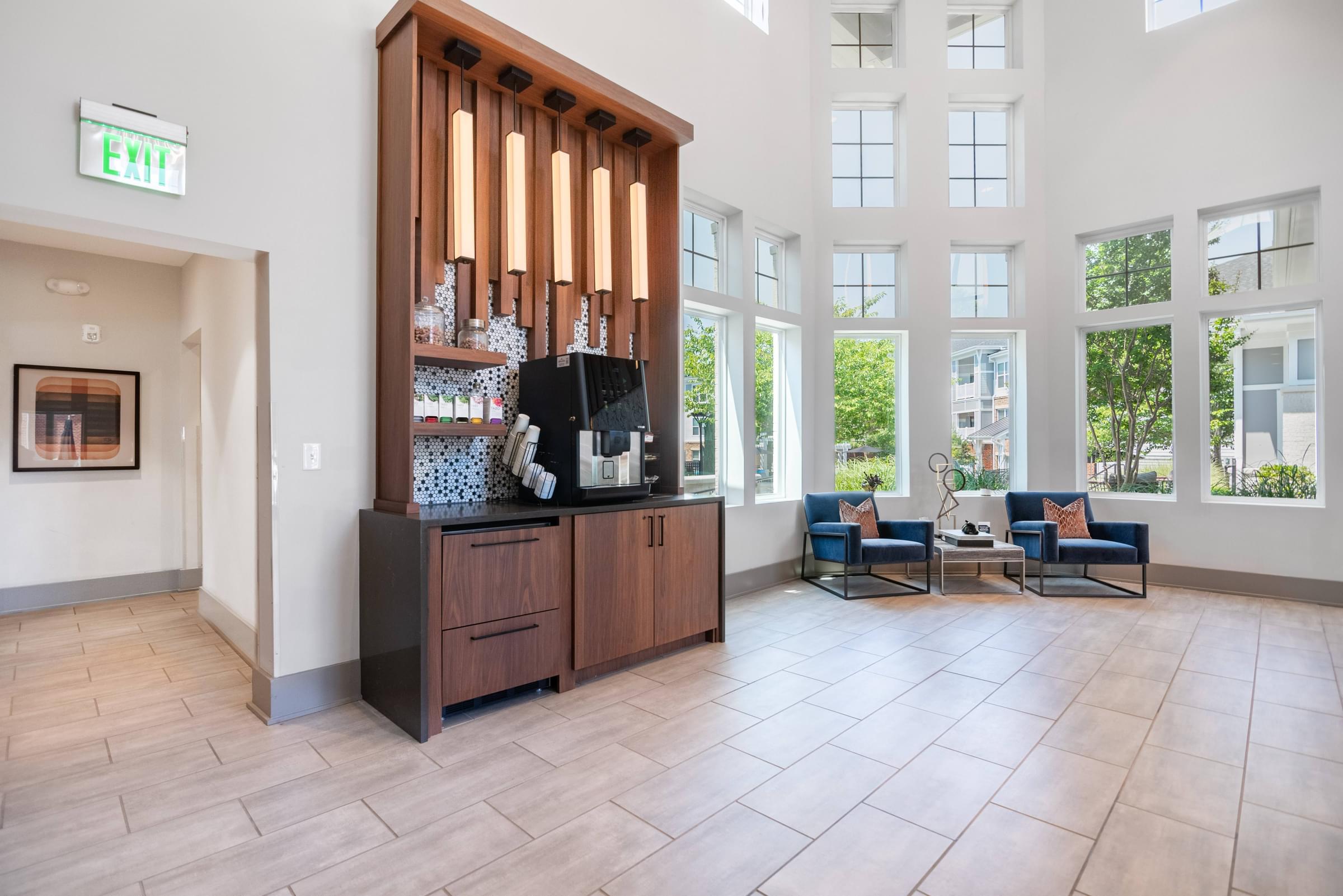 the lobby of a hotel with a reception desk and chairs