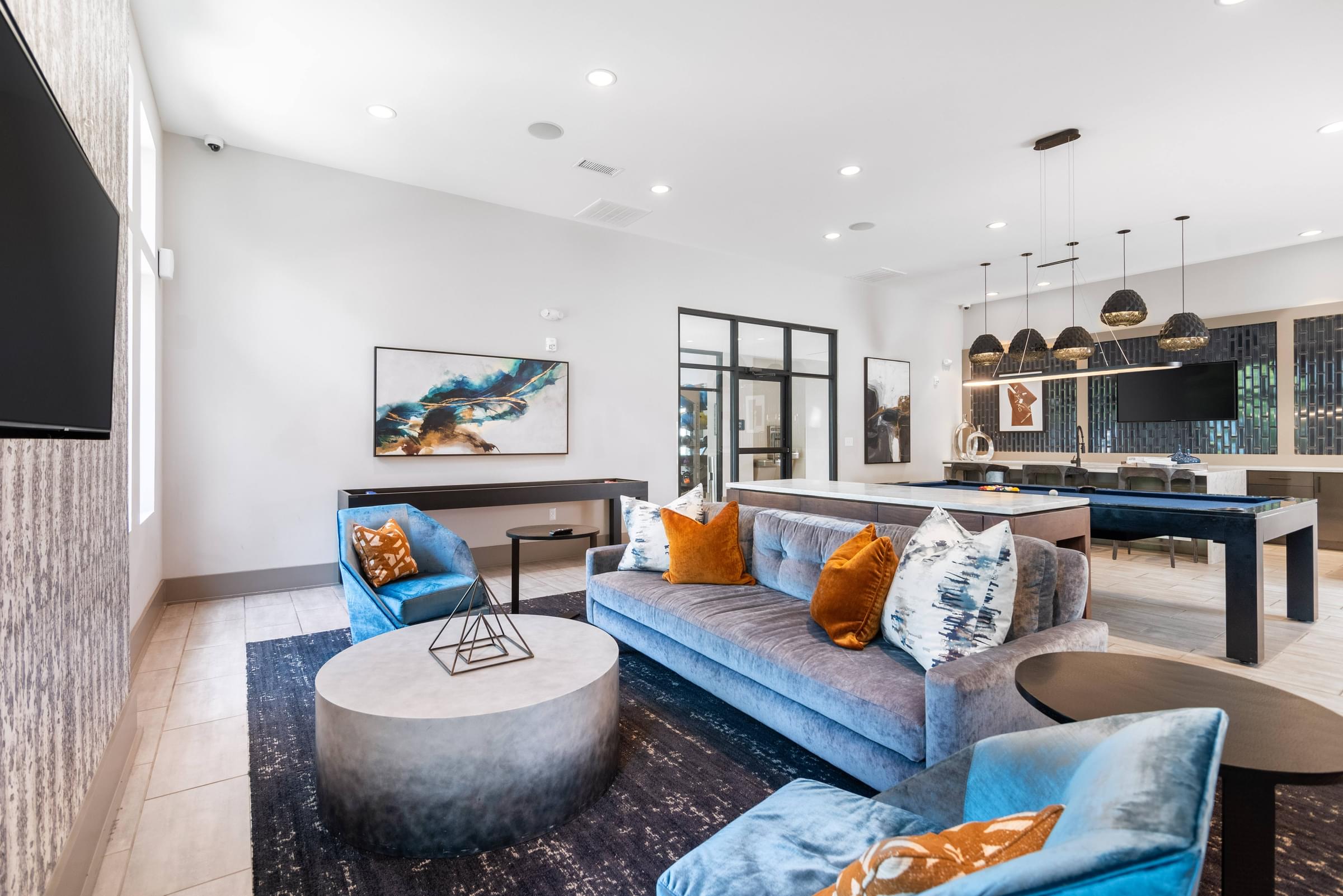 a living room with a blue couch and a table