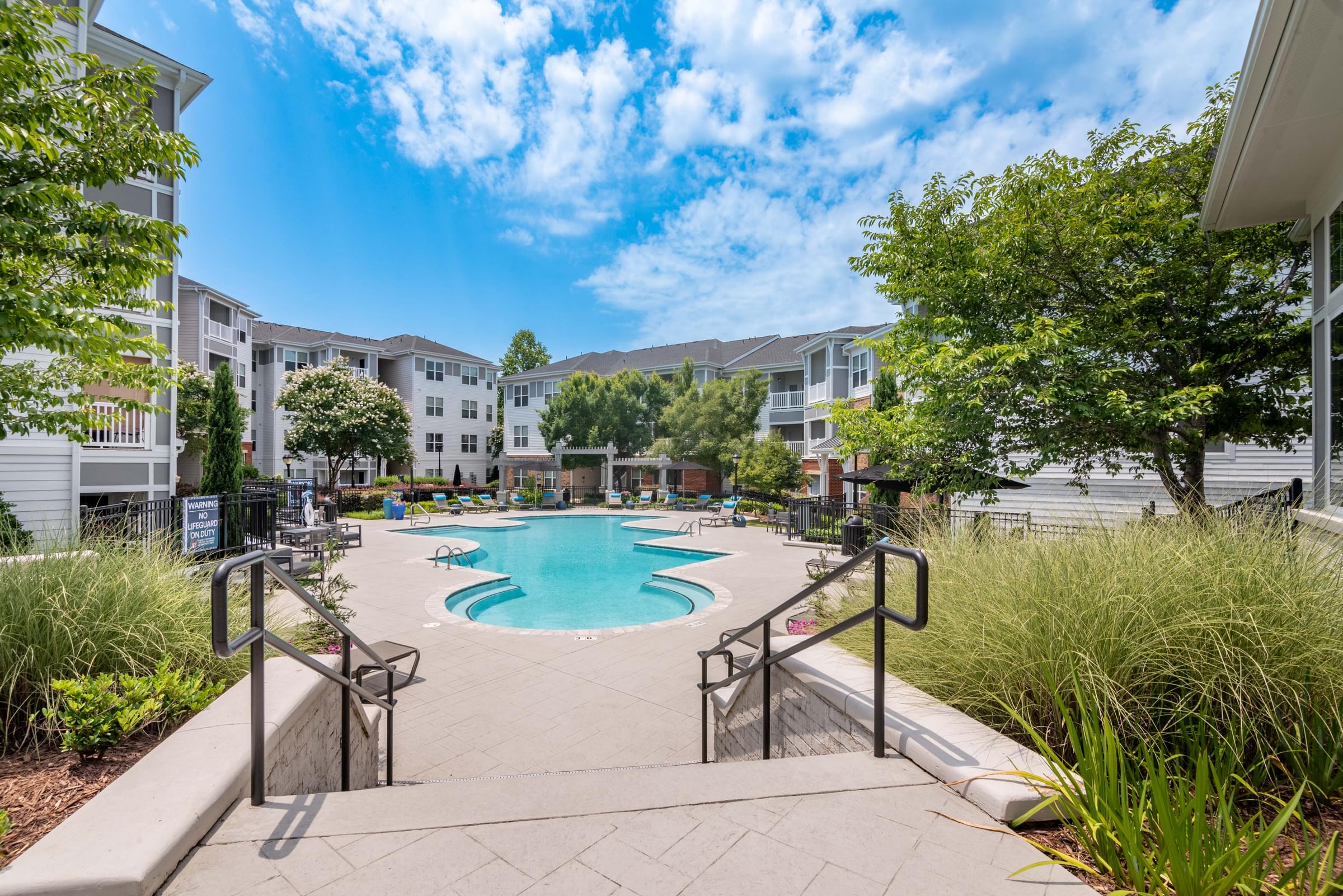 the preserve at ballantyne commons swimming pool with apartment buildings