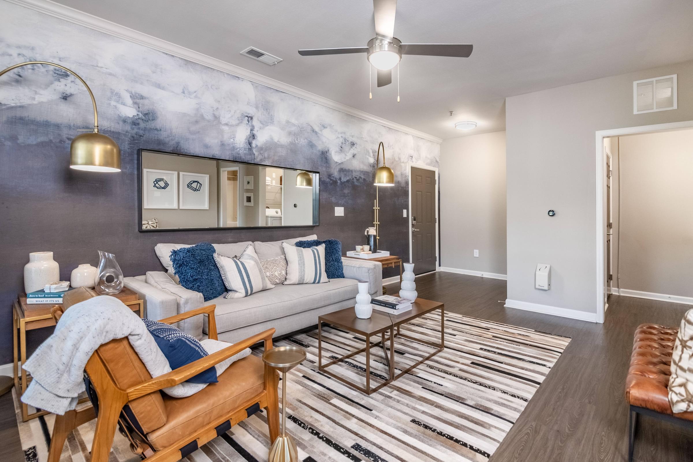 a living room with a couch and a ceiling fan