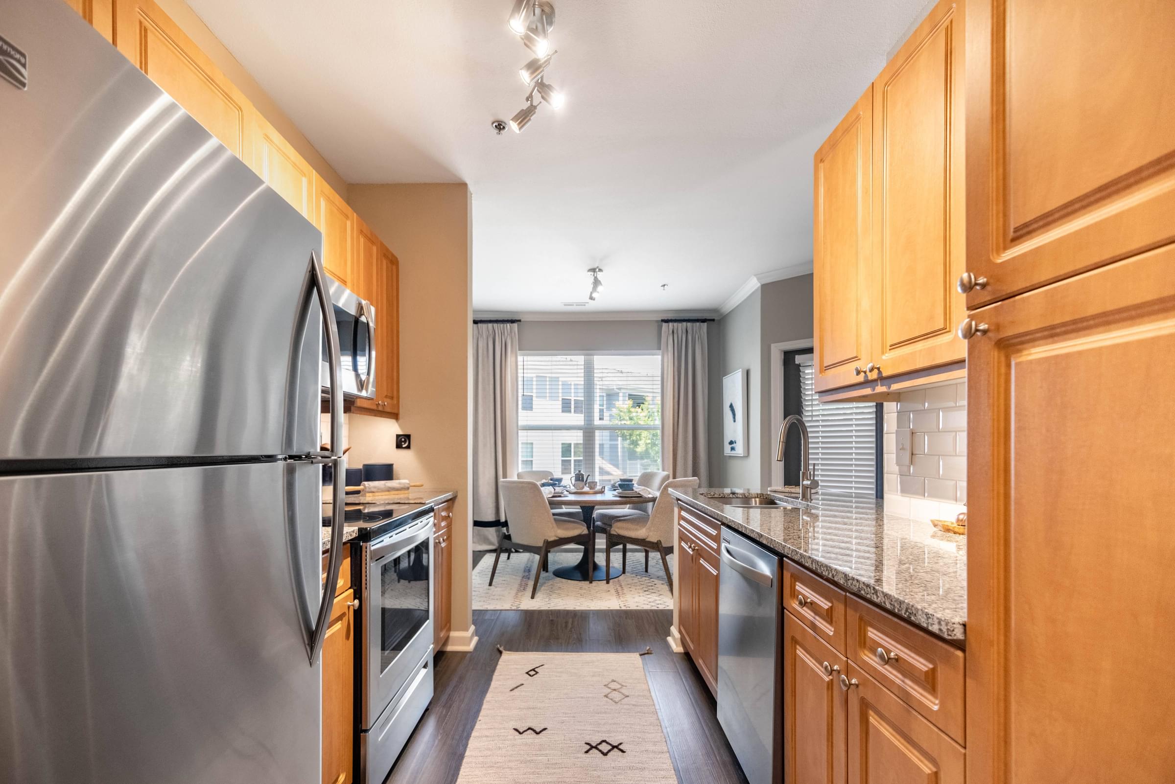 Modern Kitchen with Granite Countertop, Stainless Steel Appliances, and Designer Cabinets