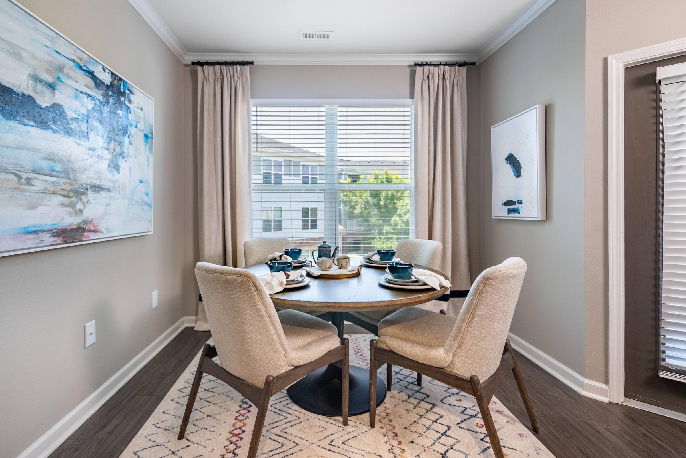a dining room with a table and chairs and a window