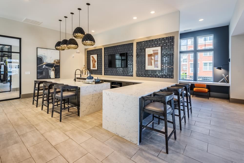 a kitchen with a marble counter top and bar stools