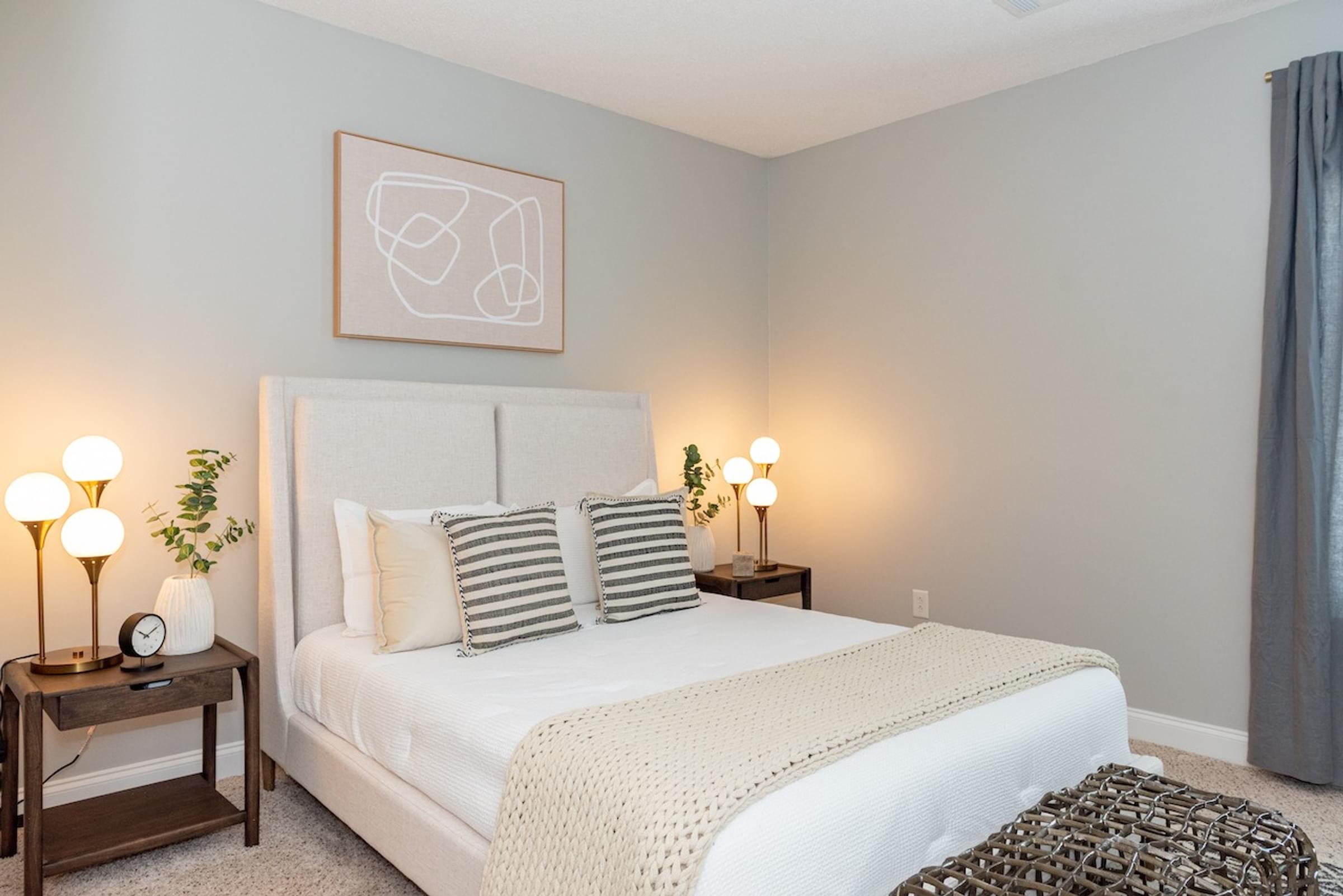 a bedroom with a white bed and grey walls