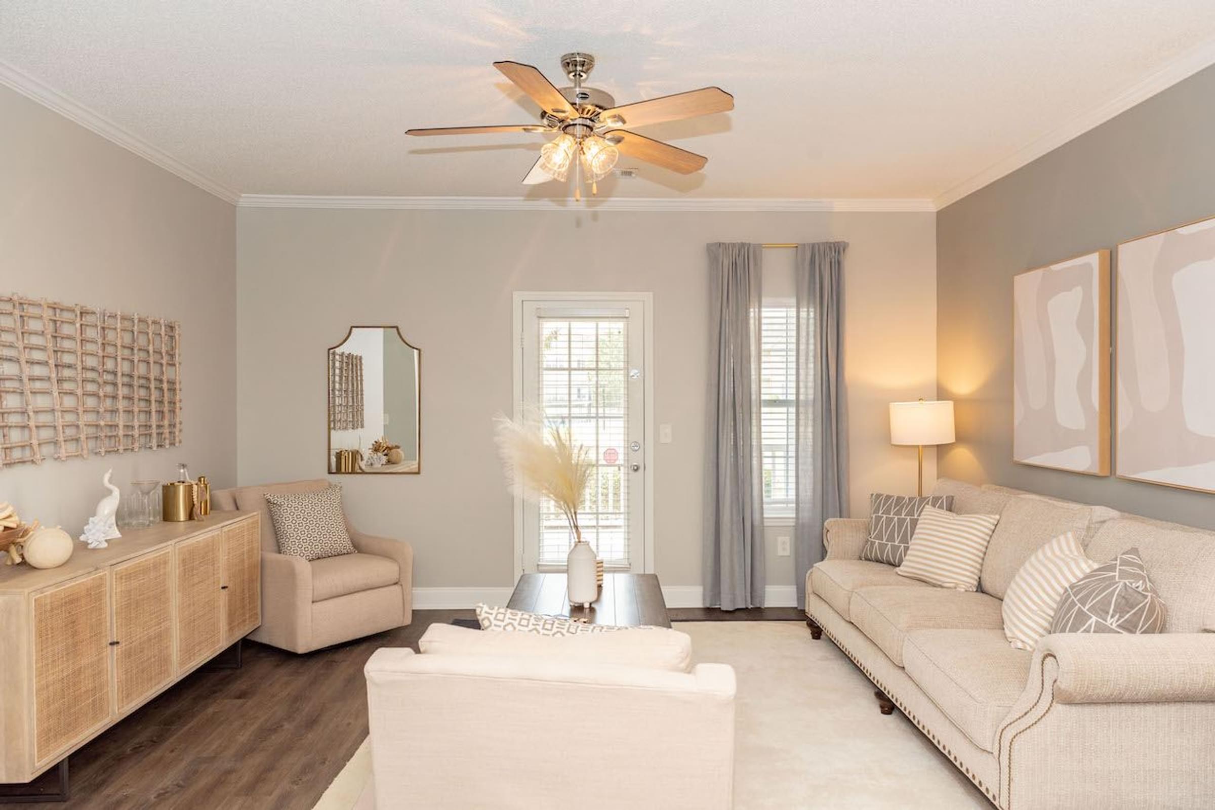 a living room with two couches and a ceiling fan