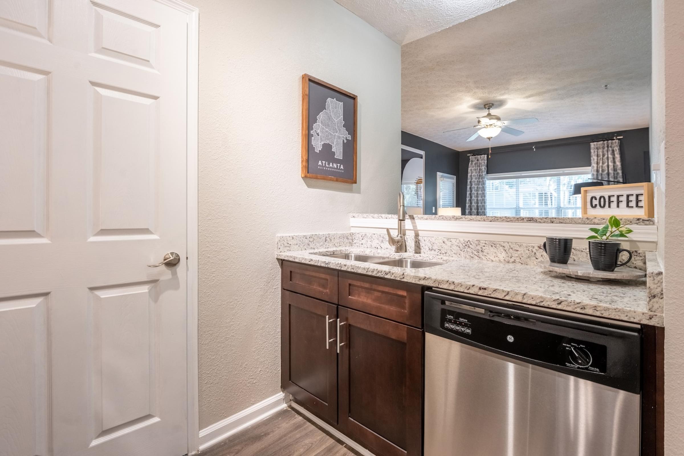 a kitchen with a dishwasher and a sink and a window