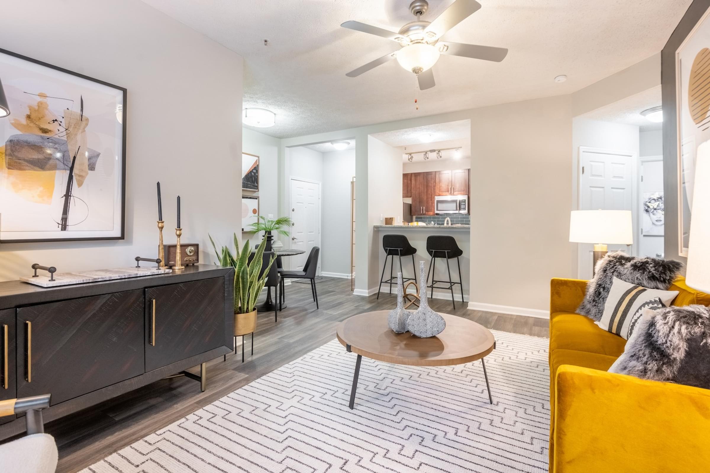 an open living room and kitchen with a ceiling fan