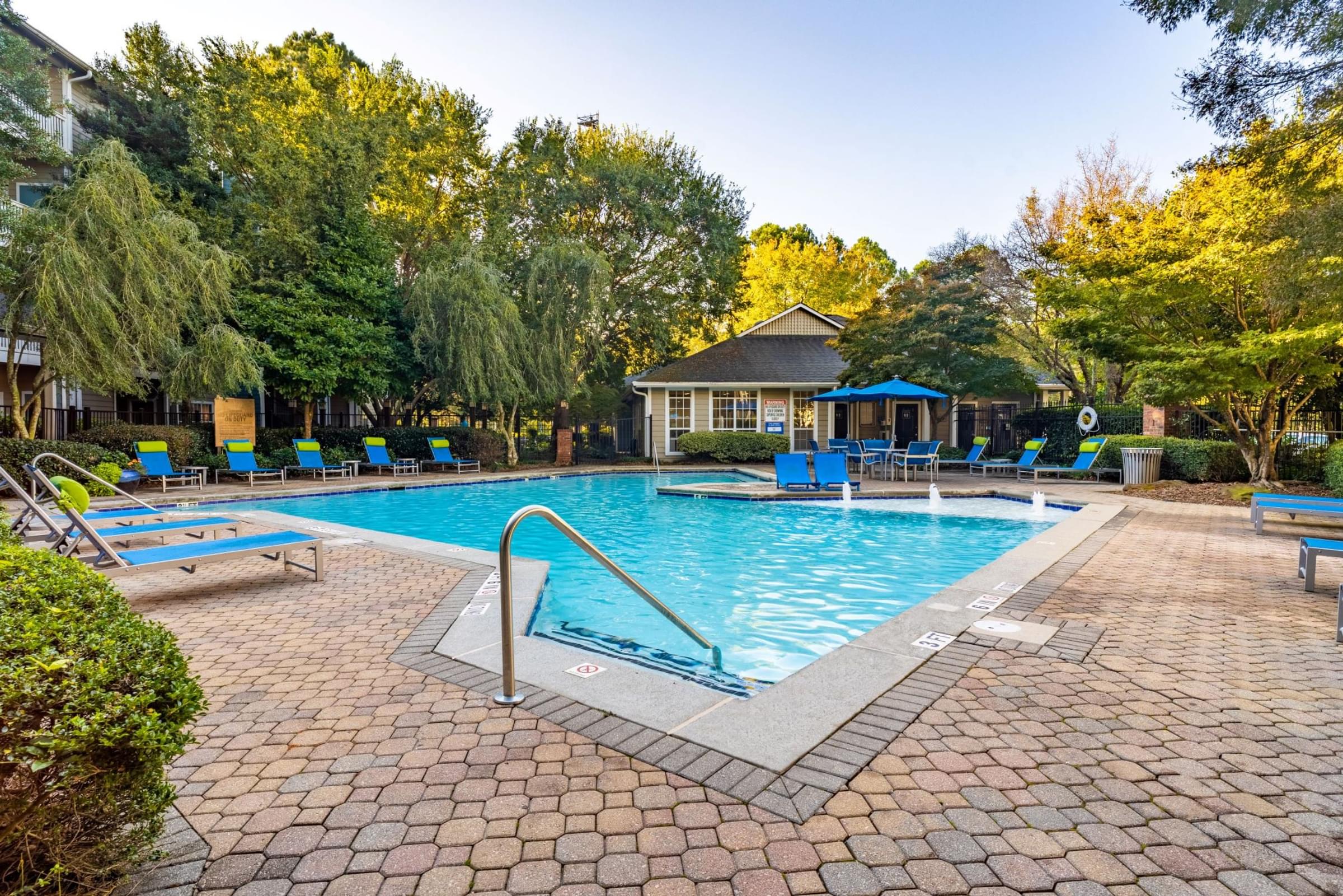 a swimming pool with a house in the background