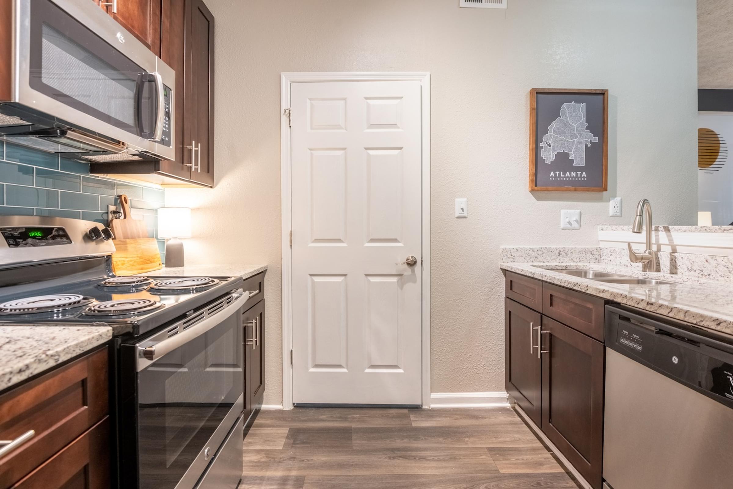 a kitchen with stainless steel appliances and a white door