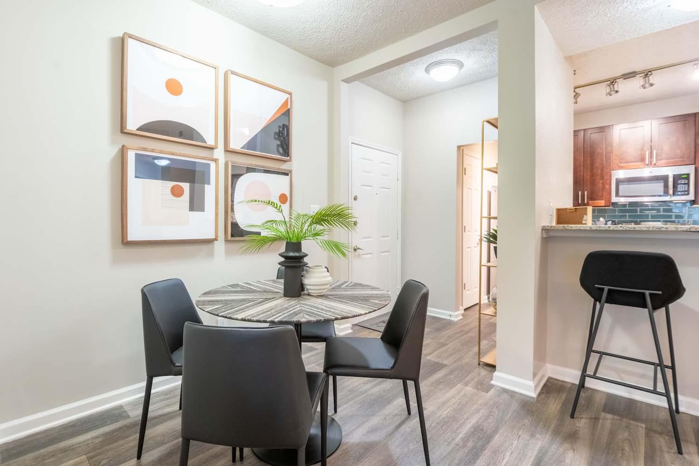 a dining room and kitchen with a table and chairs