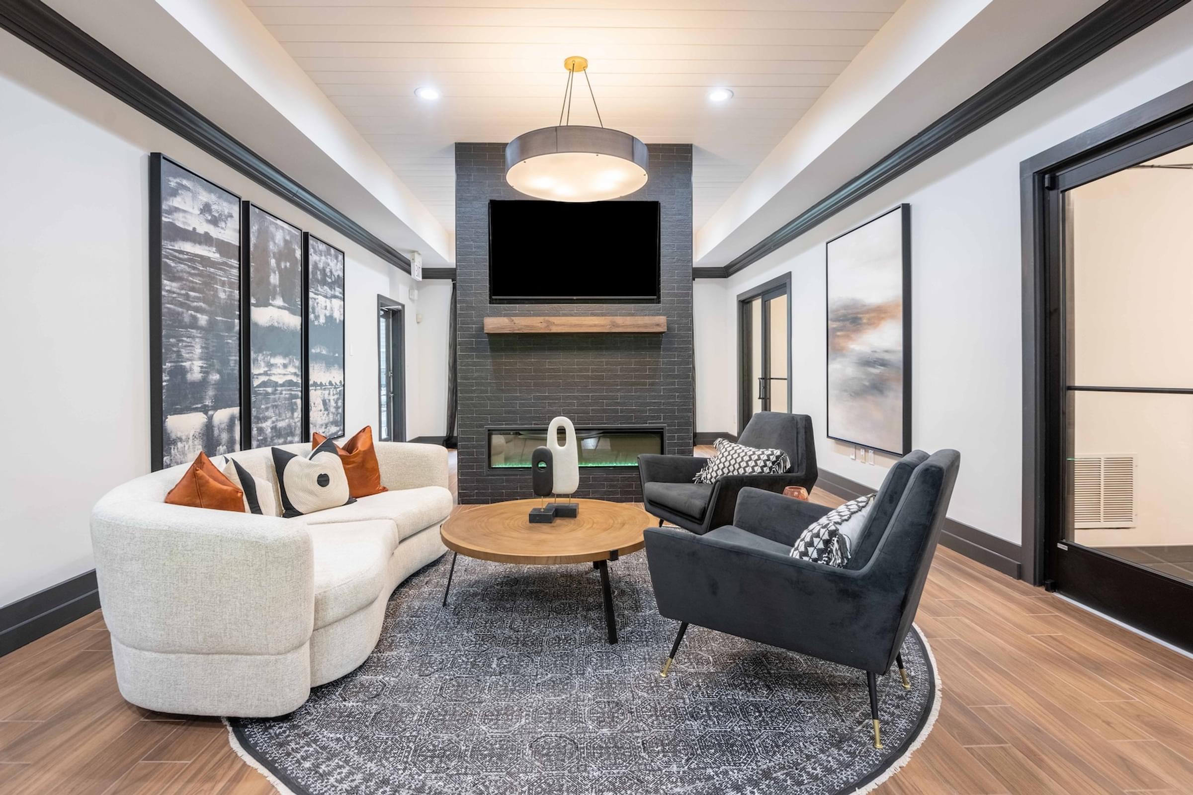 a living room with couches and chairs and a television