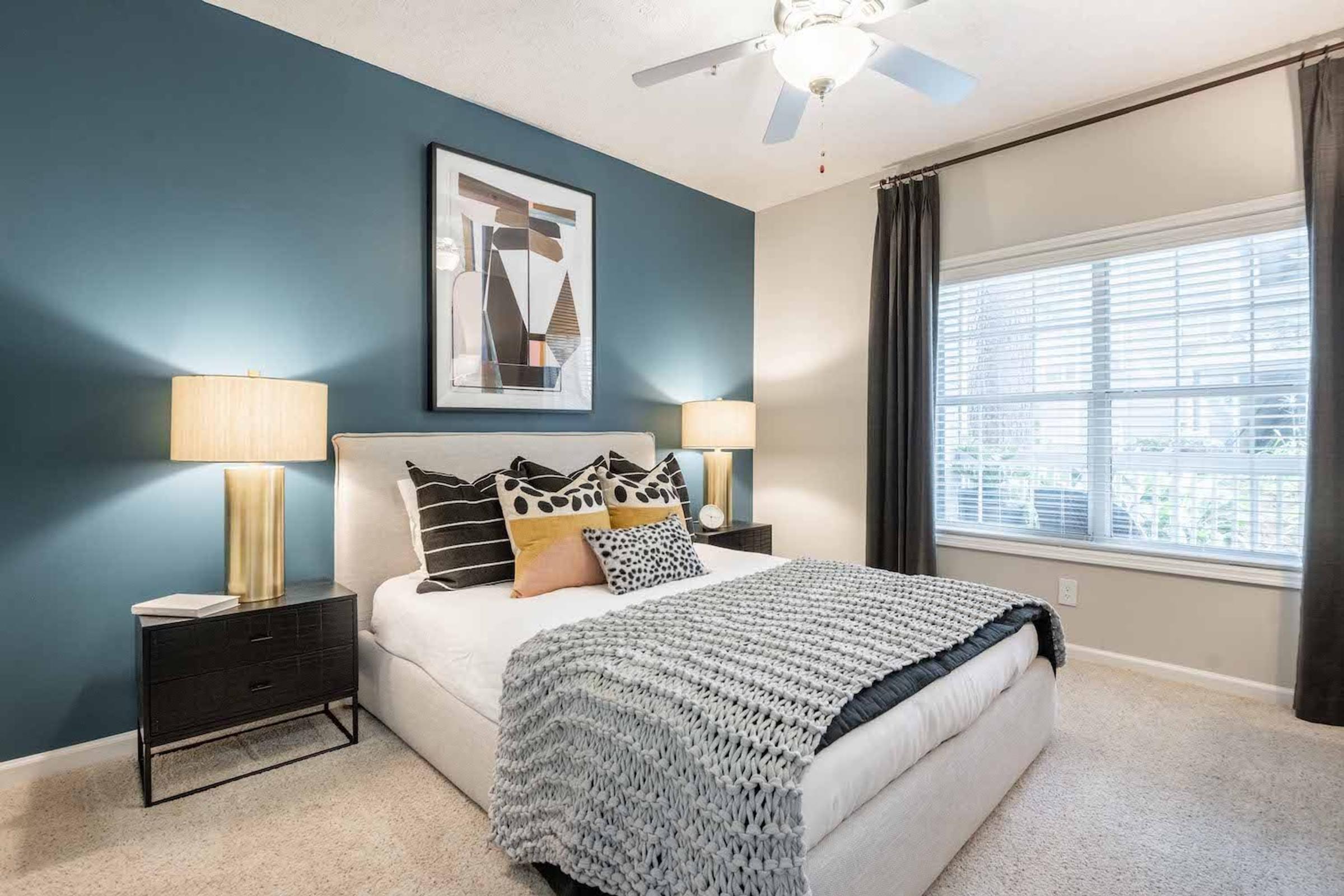 a bedroom with a bed and a ceiling fan