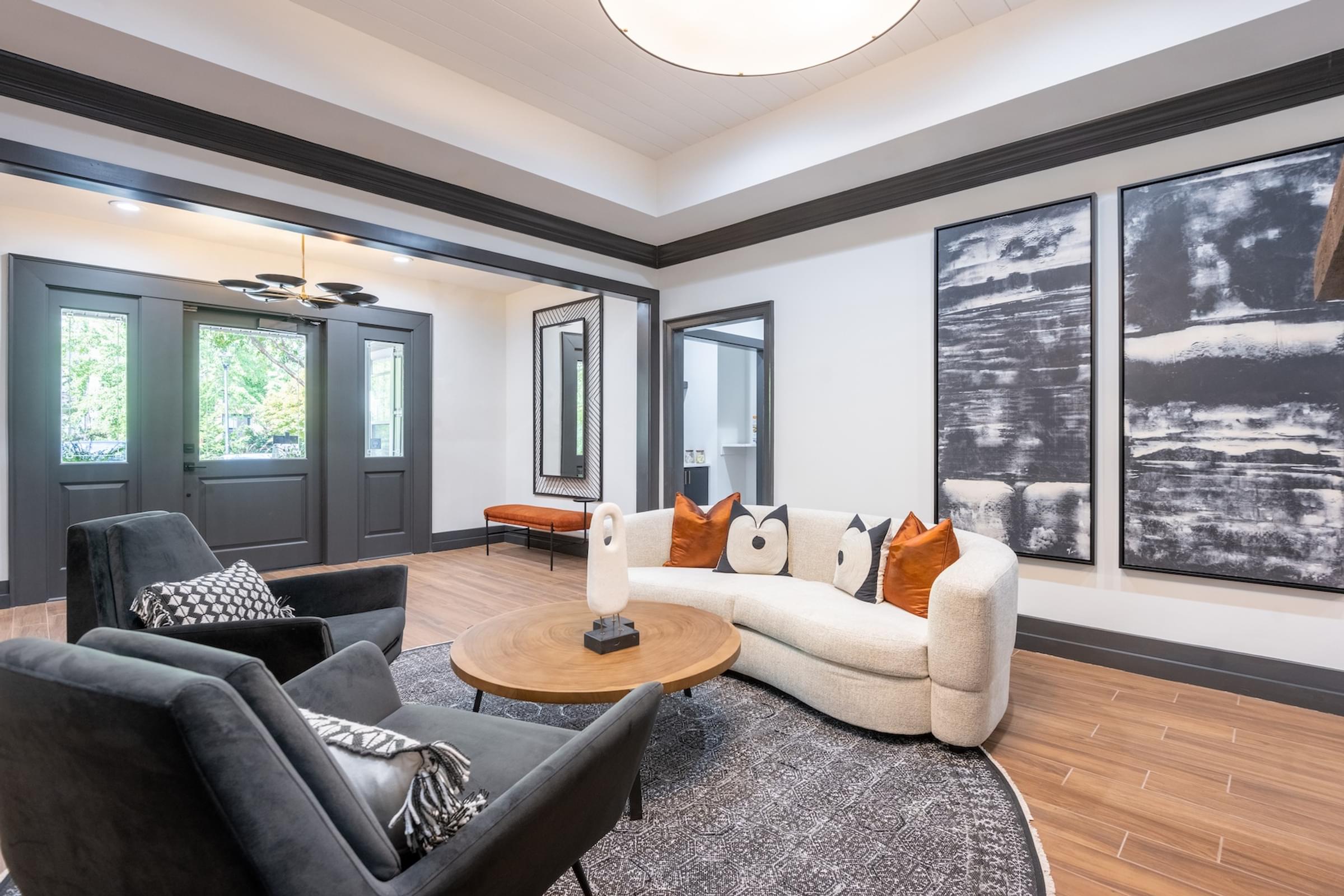 a living room with a white couch and chairs and a coffee table