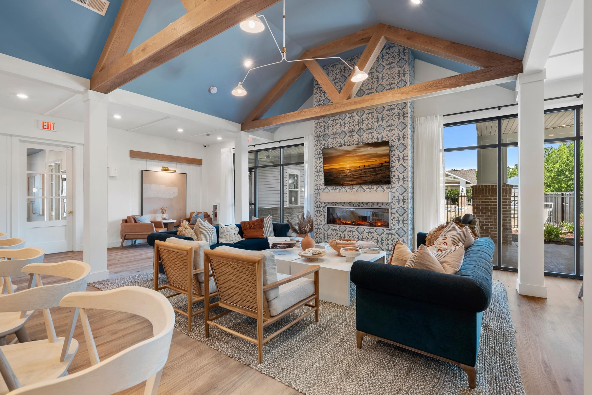 a living room with couches and chairs and a fireplace