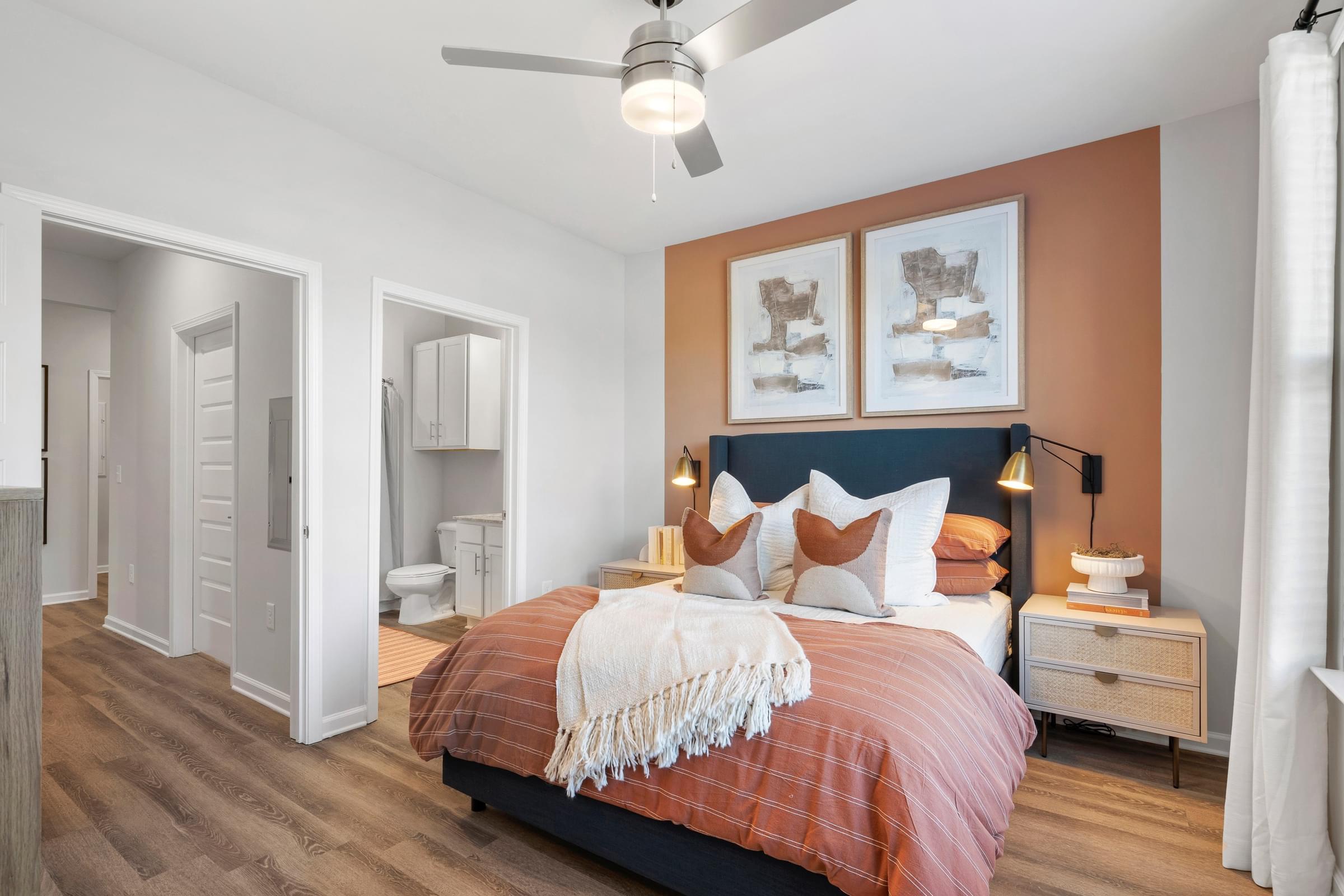 a bedroom with a bed and a ceiling fan
