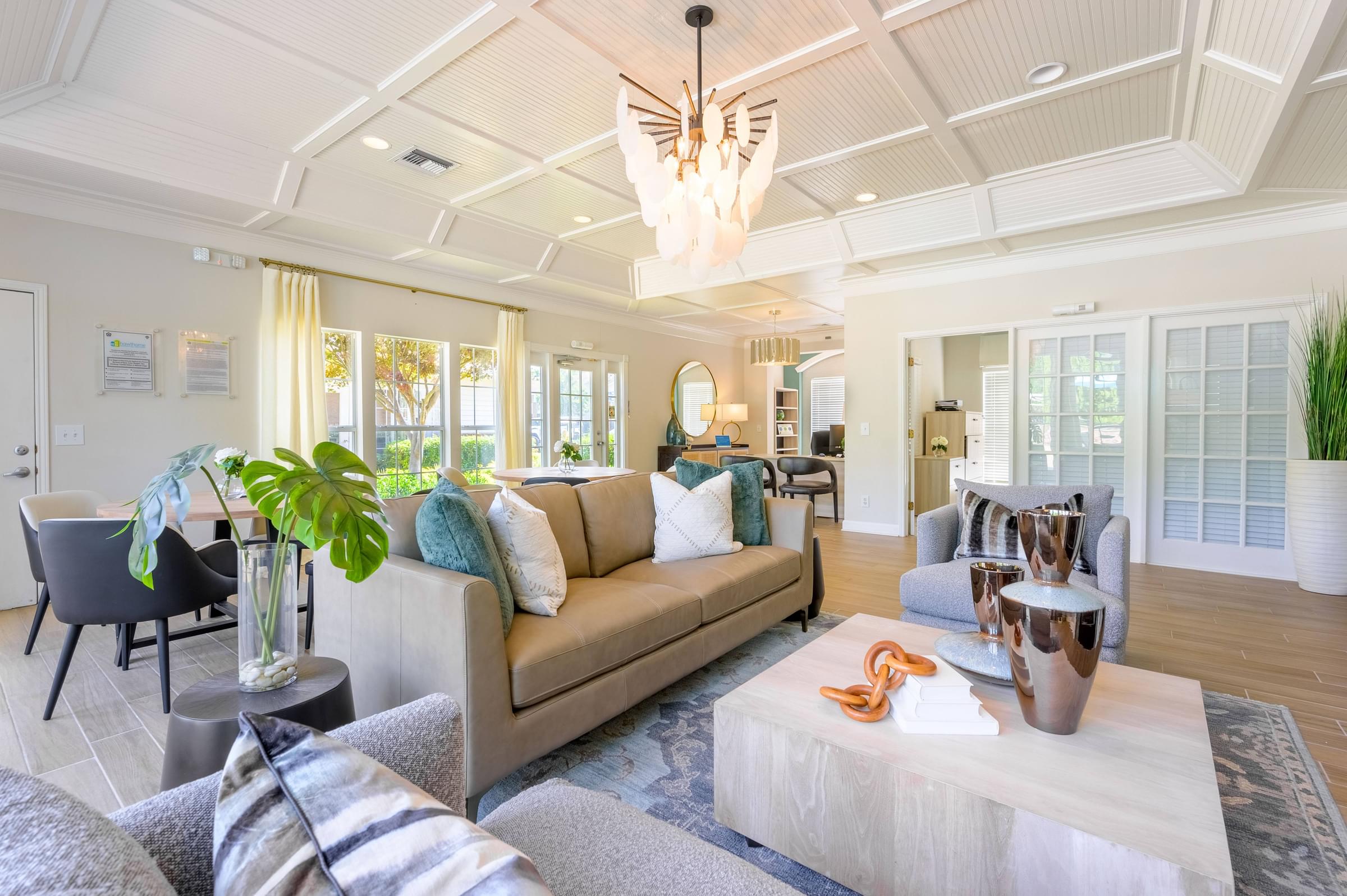 A living room with a couch, chairs, and a coffee table.