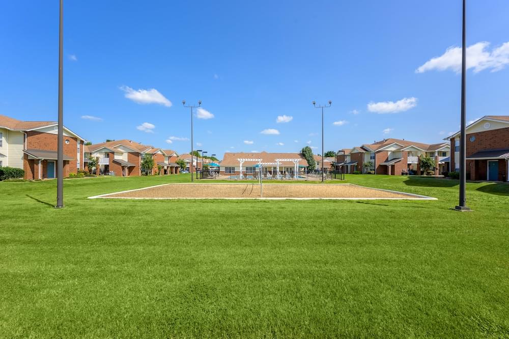 a baseball diamond with houses in the background