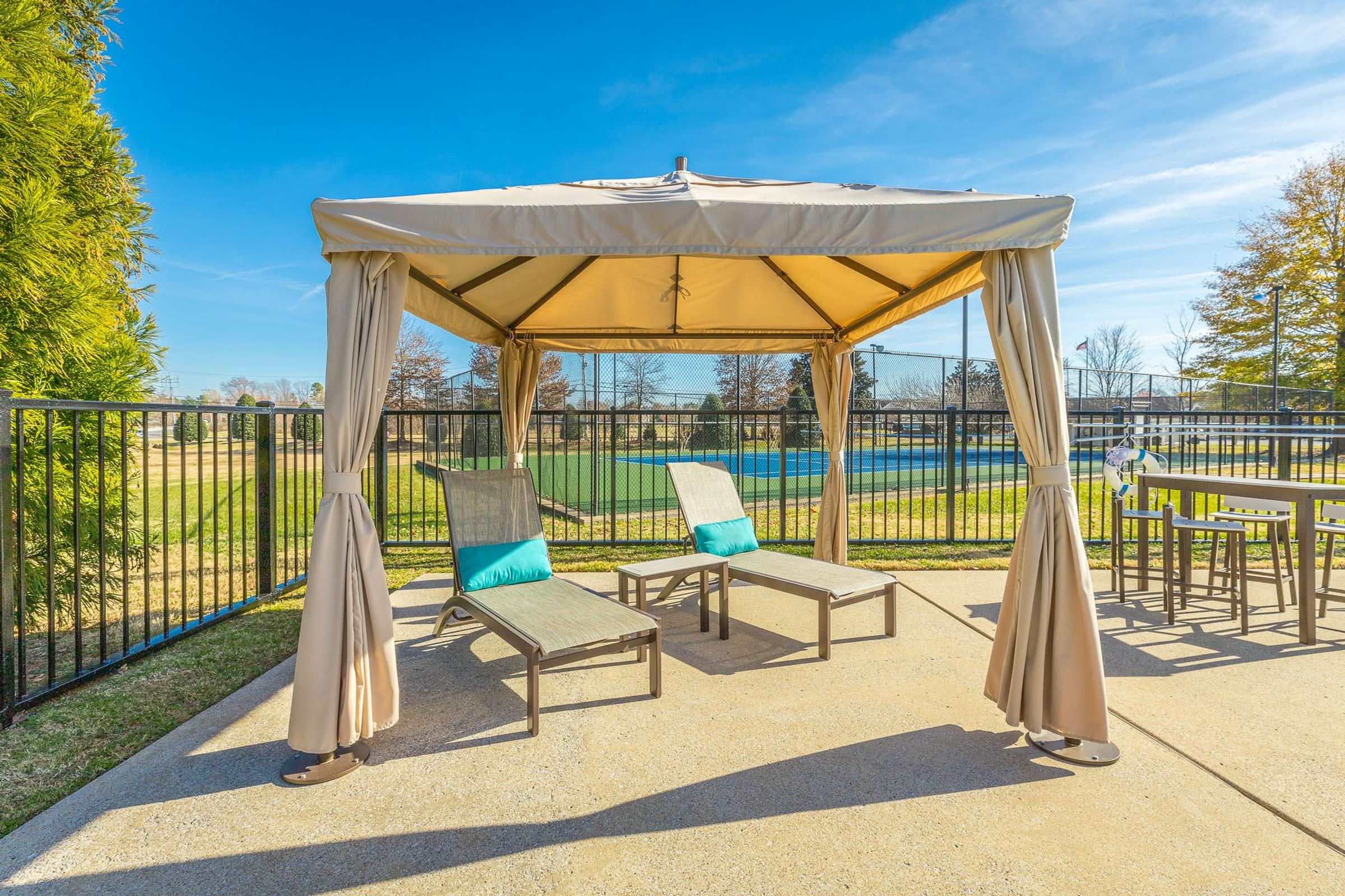 A patio with a canopy and chairs is set up.