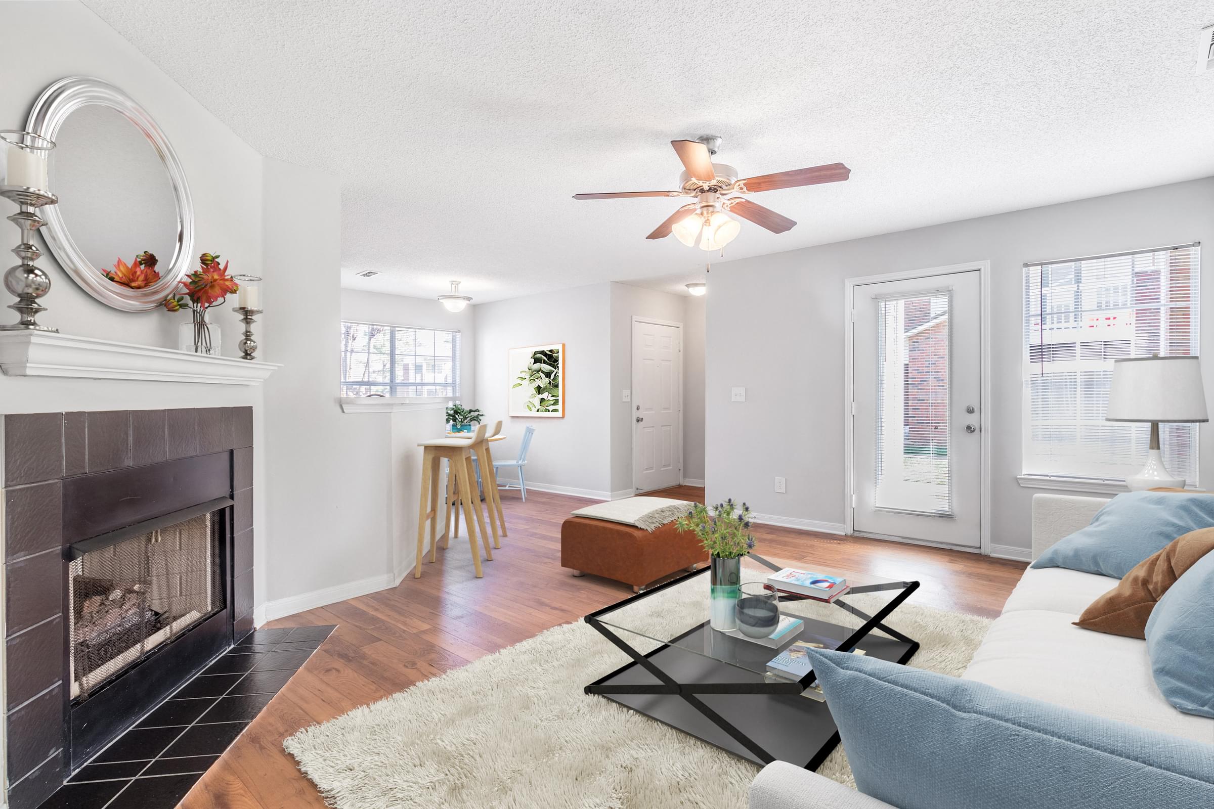 A living room with a fireplace, a couch, and a coffee table.