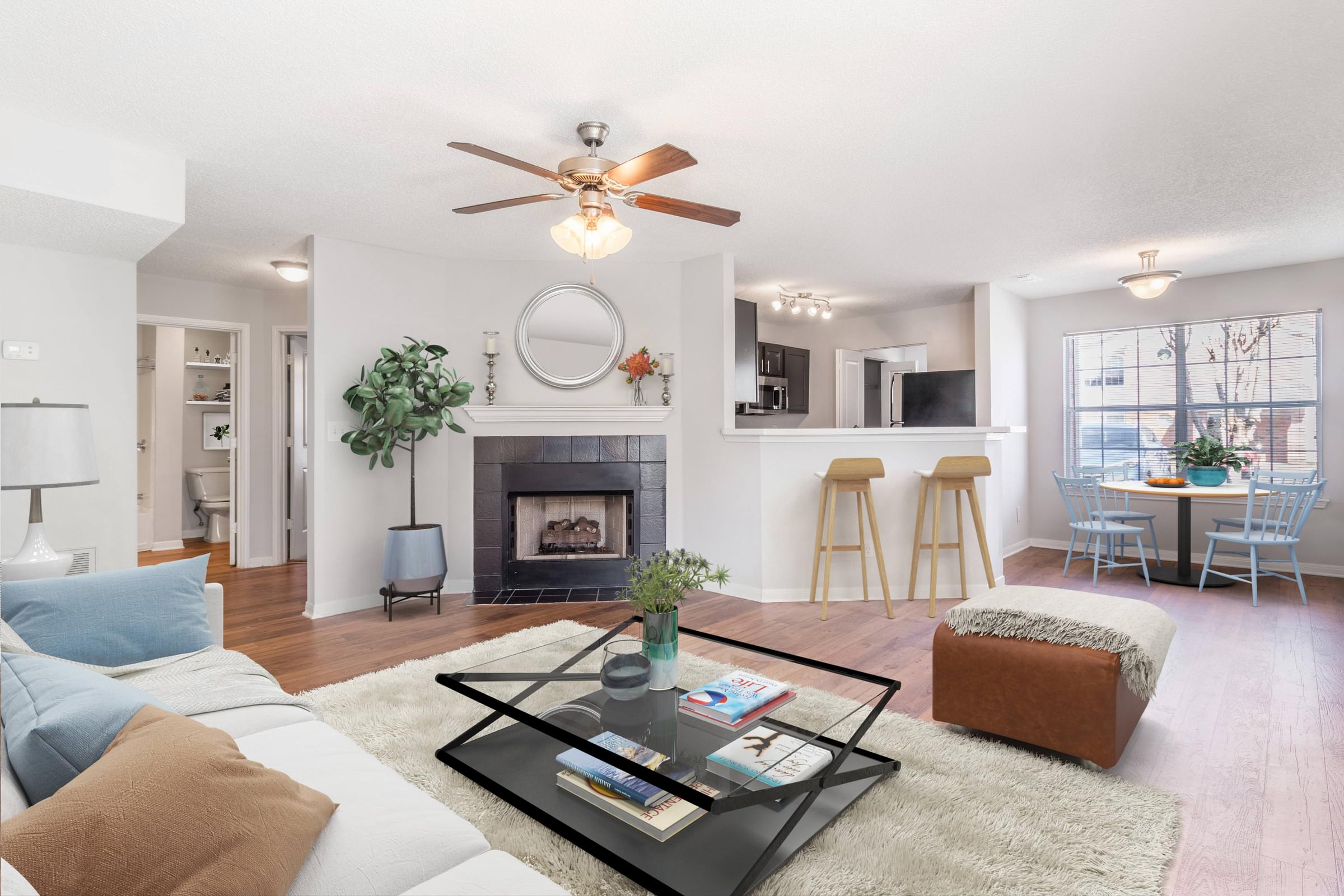 A living room with a fireplace, a white couch, and a coffee table.
