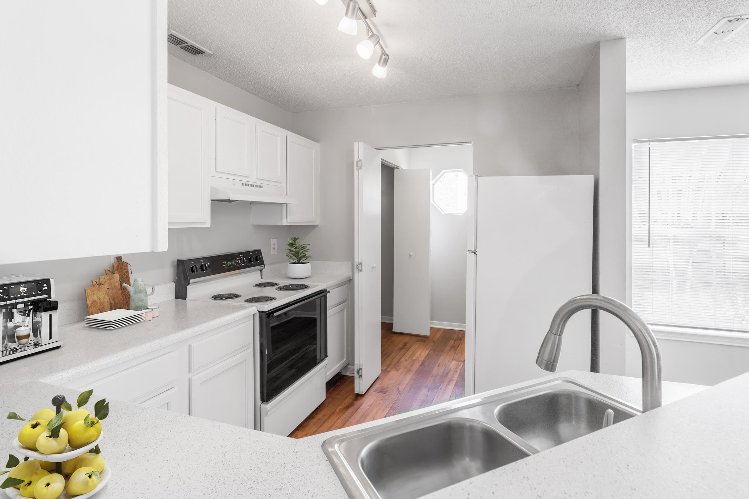 A kitchen with a stove, oven, and sink.