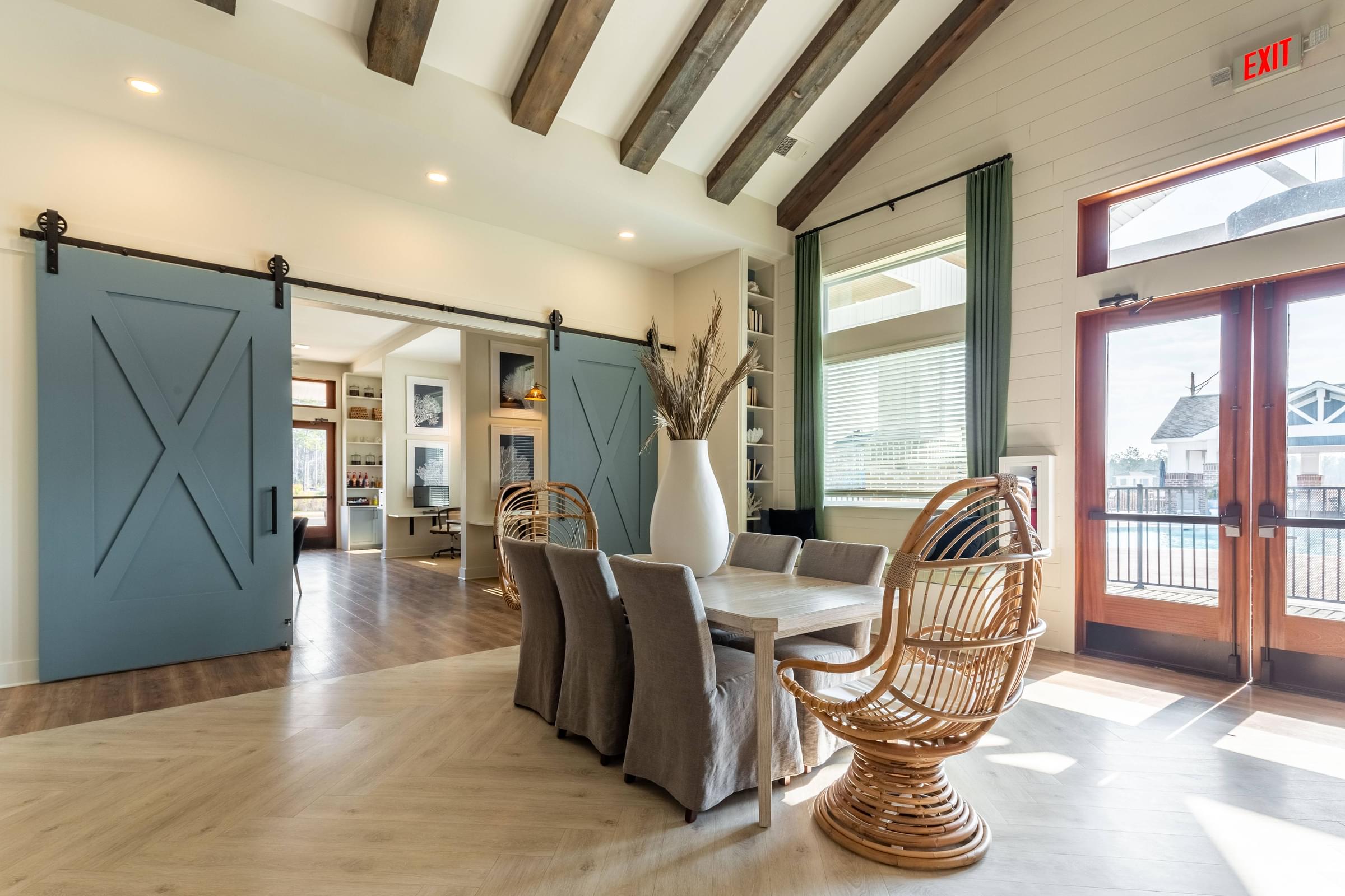 a dining room with a table and chairs and sliding barn doors