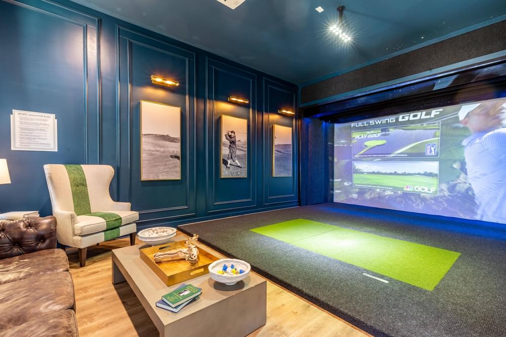 a game room with a projector screen and a couch