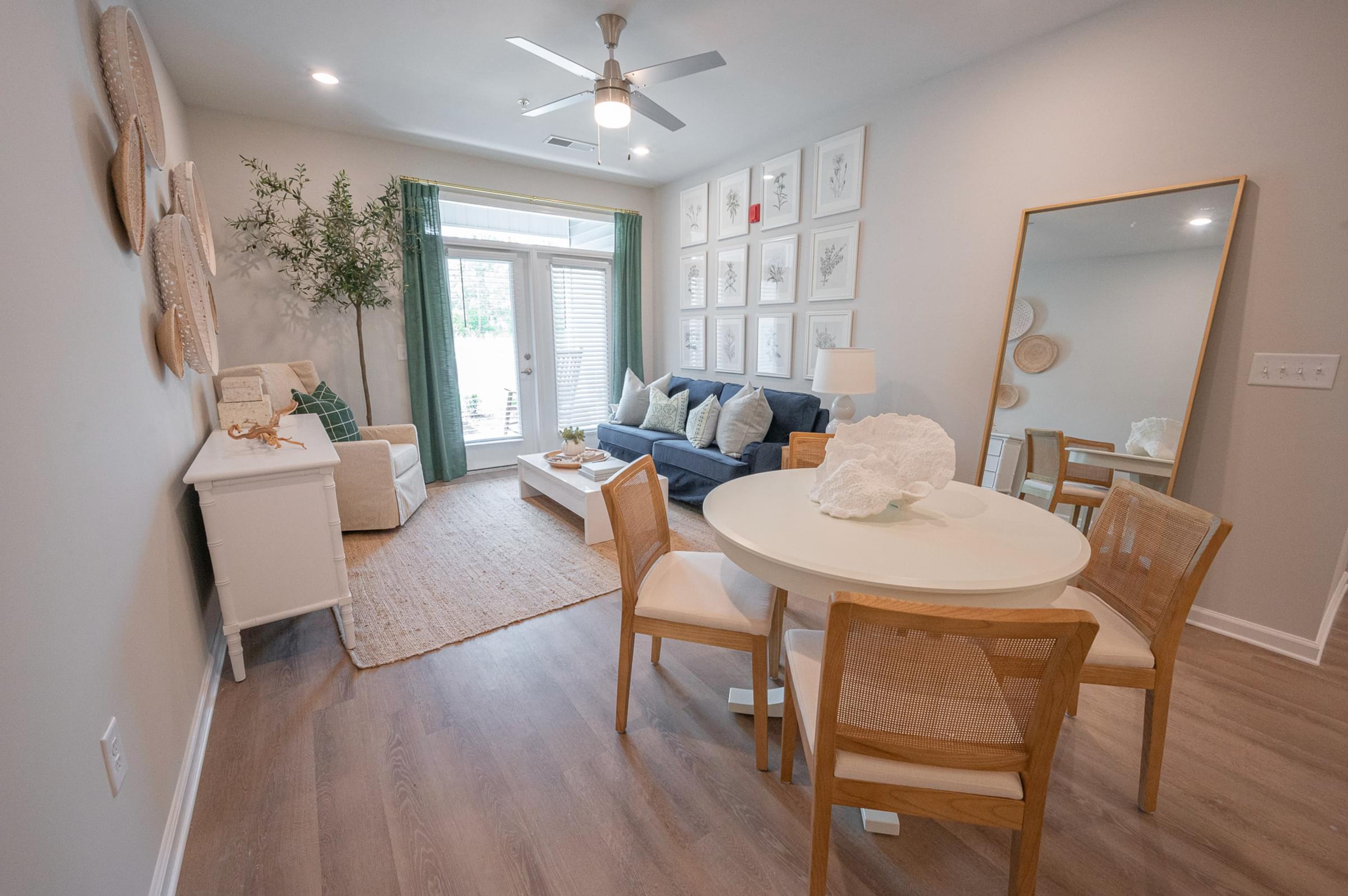 an open living room and dining room with a white table and chairs