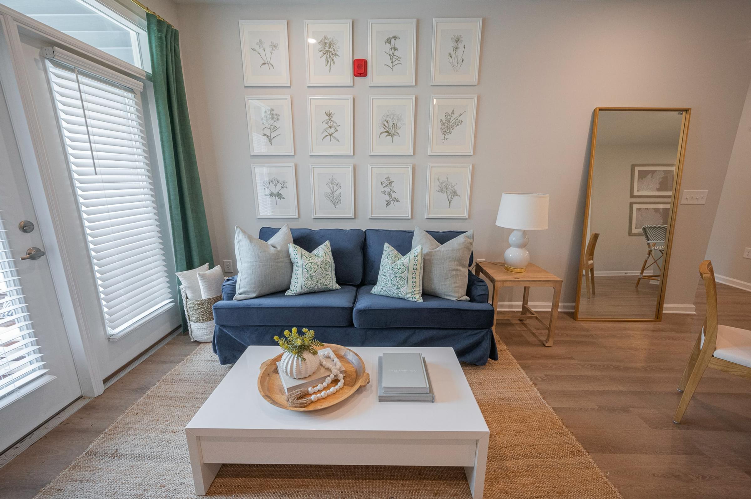 a living room with a blue couch and a coffee table