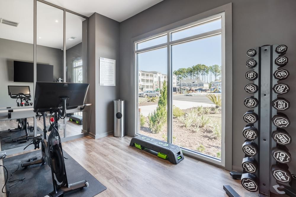 a home gym with a large window and a bike in it
