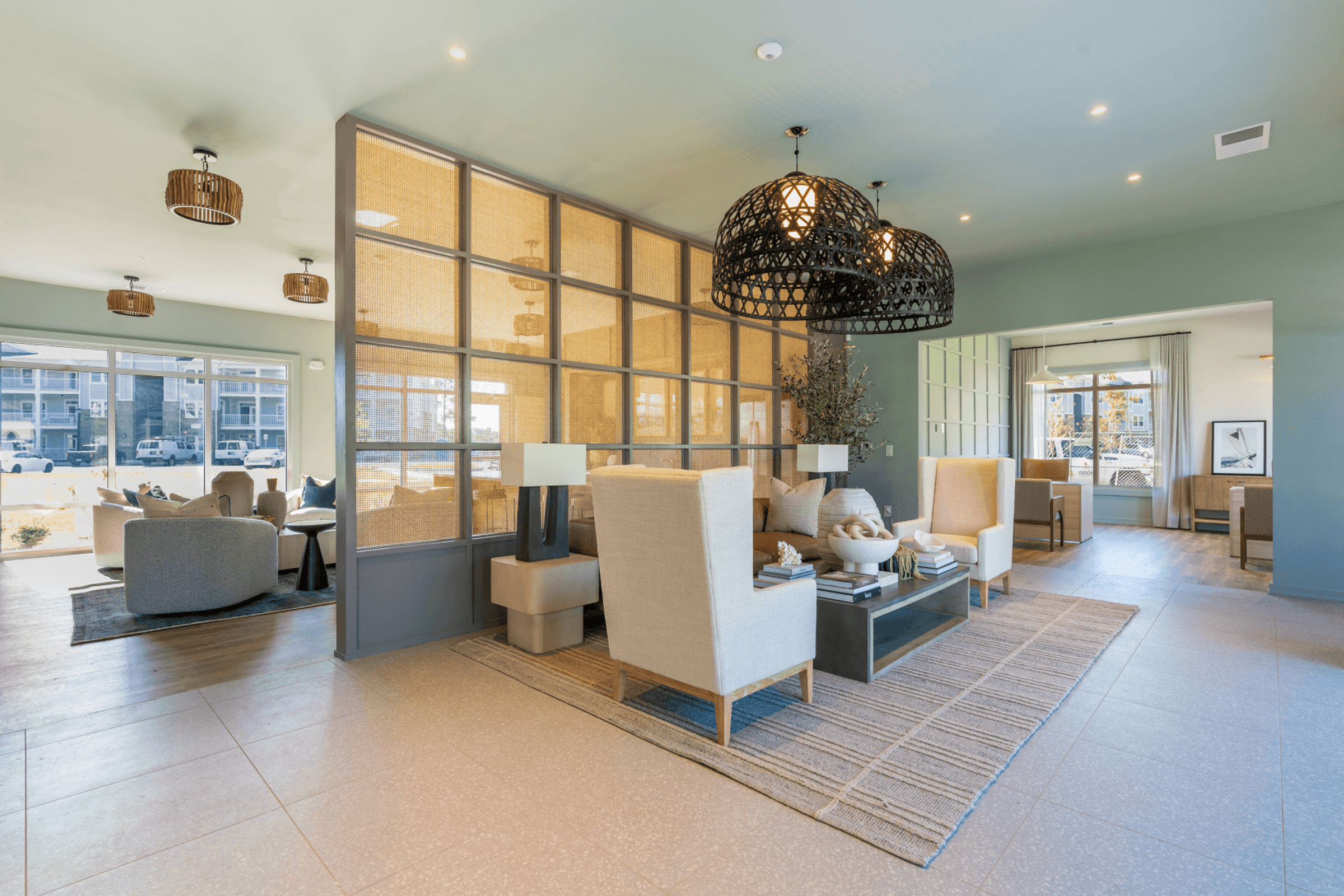 a living room with couches and chairs and a large window